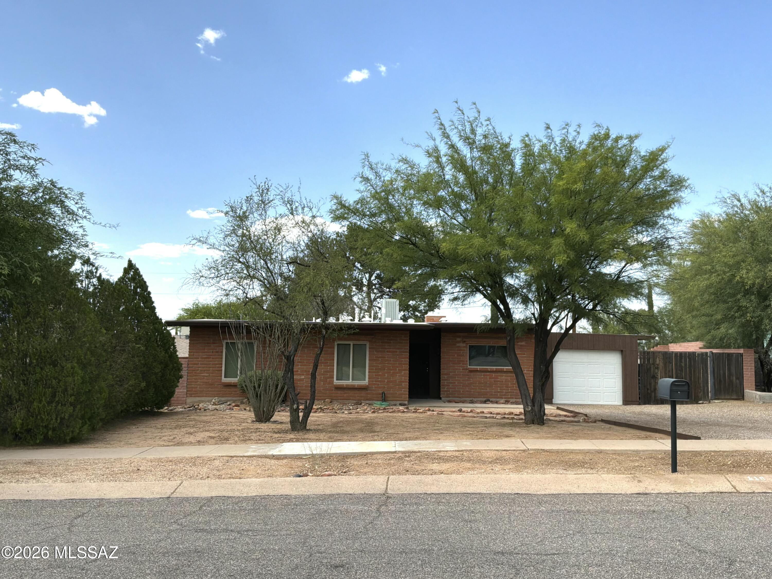 Ready to move-in! Adobe block, 3 bedroom home in a well established Corona de Tucson neighborhood. 
Cozy living room with beehive gas fireplace. Dining area off kitchen. Refrigerator, range, washer & dryer included. (Dishwasher is not operable). Solid oak interior doors. Beautiful French doors lead to a small enclosed patio with access to garage or backyard. Mature landscaping, raised flower beds. Citrus trees(Orange, grapefruit & lemon). Backyard privacy. Roof was replaced 2023. New gutters. Updated triple pane windows. 4 Solatubes in home. Security screen doors and bars on rear windows. 1-car Garage with storage closet. Space available for small RV. Seller  lived in and cared for this property since 1986. Walking distance to award winning Vail schools Sycamore & Corona Foothills. NO HOA