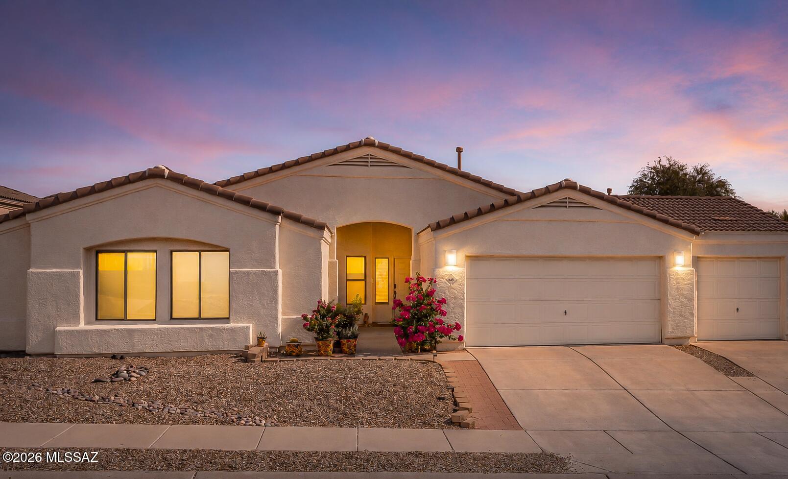 Welcome home to this beautifully maintained and updated 3-bedroom, 2-bathroom home offering 2,019 square feet of thoughtfully designed living space and an oversized 3-car garage. This bright, open floor plan provides vaulted ceilings, abundant natural light, and NO CARPET--just durable tile and engineered wood flooring throughout.  The kitchen features granite countertops, tons of cabinet and counter space, stainless steel appliances, and a newer dishwasher.  The generously sized primary suite offers a luxurious ensuite bathroom with a double vanity, beautifully tiled walk-in shower, separate soaking tub, oversized walk-in closet, and private water closet. All three bedrooms feature walk-in closets!  The backyard of this elevated lot provides mountain views, mature landscaping, and a fruit-producing lemon tree.  Additional upgrades and features include a newer garage door, newer water heater, newer water softener system, Ring doorbell and backyard security camera.  All appliances convey, including the refrigerator, washer, and dryer!  All window coverings stay!  All outdoor potted plants and backyard furniture stay!  Located within walking distance of Naranja Park, you'll have convenient access to hiking trails, a splash pad, sports fields, dog parks, pickleball courts, and a pump track--making it easy to enjoy everything this wonderful community has to offer.  This move-in-ready home combines comfort, quality, and an unbeatable location. Don't miss your opportunity to make it yours!