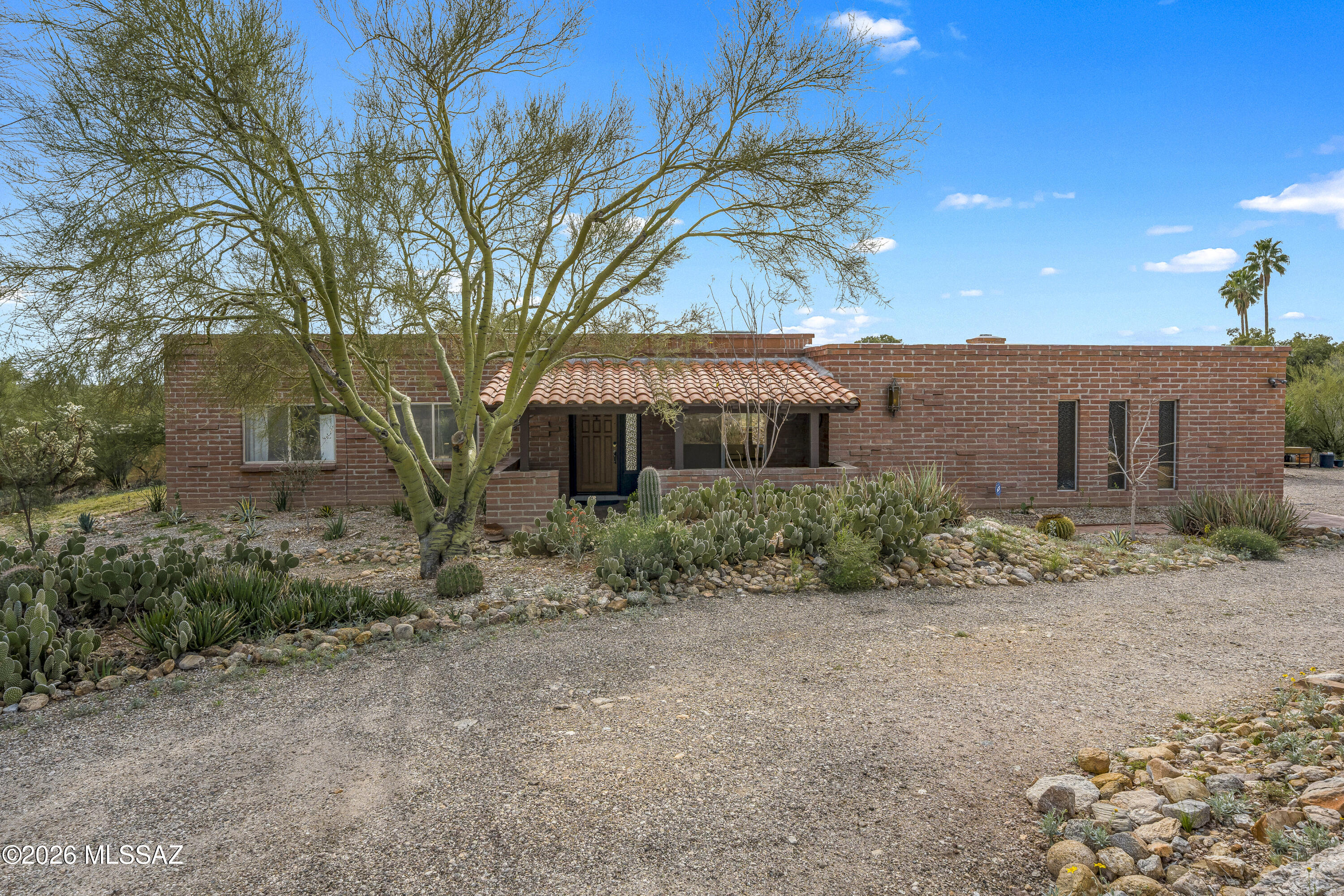 Seller will accept or counter offers between $599,990.- $610,000. Welcome to your Catalina Foothills Oasis!This home sits on .748 acres, with spectacular views of the desert, mountains, sunrise, and sunsets. The owner has carefully planted more than 20 native trees and desert shrubs, creating a thriving habitat that attracts birds, pollinators, and other native species. A welcoming courtyard entry invites you into the heart of the home. Inside, sliding glass doors in multiple rooms fill the home's interior with an abundance of natural light. The kitchen is light and open, flowing seamlessly into a cozy family room with exposed-beam ceilings and a wood-burning beehive fireplace. The rear of the home has a large, extended, covered back patio and an inviting pool. The yard is snake-proofed with an outdoor predator-proof kennel to keep your small pets safe. Ideally located on a low traffic, quiet street near Sabino Canyon, hiking trails, restaurants, grocery stores, specialty shops, and schools, this home offers both serenity and convenience. Be sure to review the list of recent owner improvements!