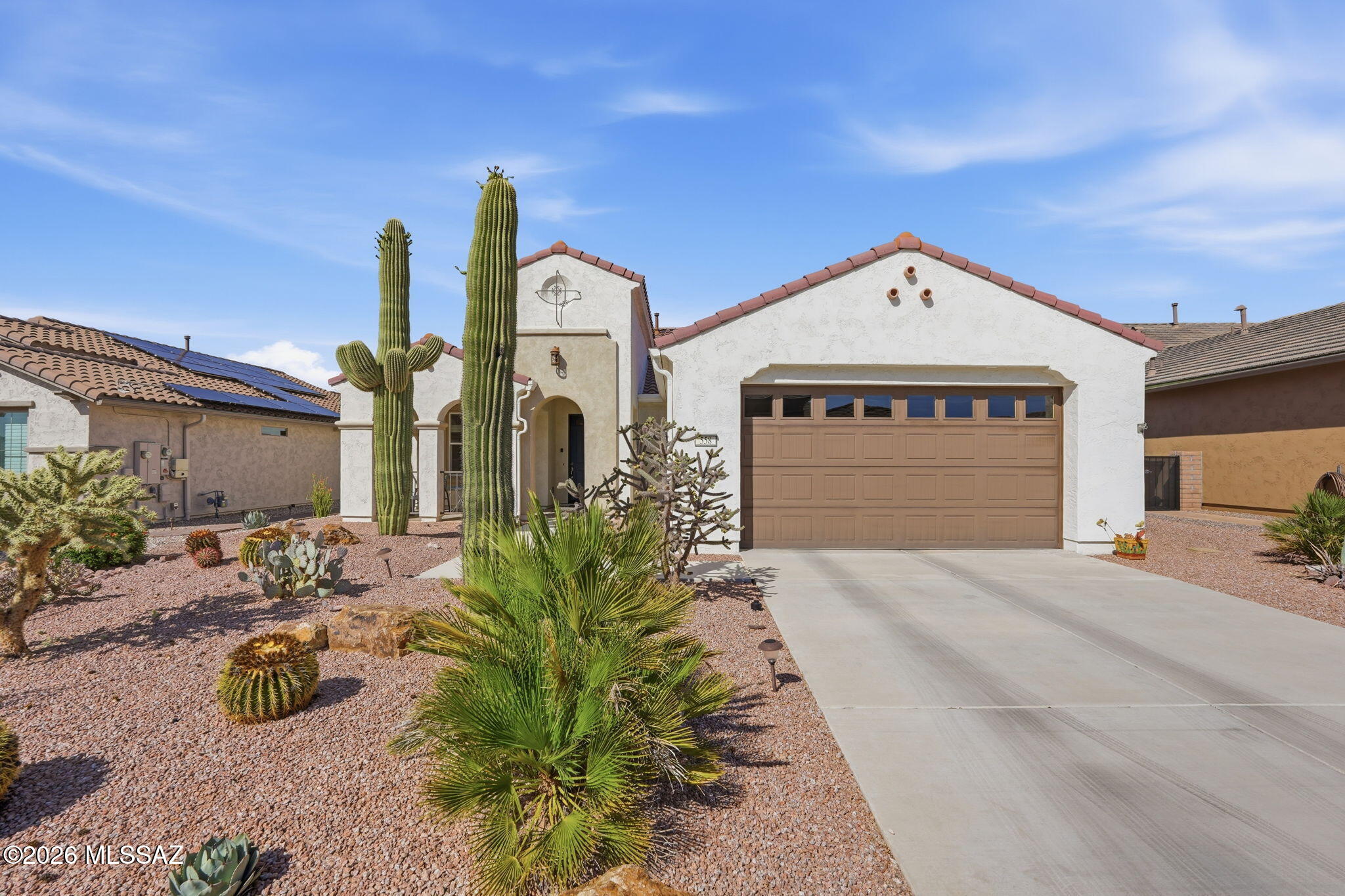 Built in 2021, this highly desirable Mandara floor plan with the extended option is located within the premier active-adult resort community of Quail Creek. Offering 1,916 square feet of thoughtfully designed comfort and functionality, this home combines modern construction, flexible living areas, and low-maintenance ownership in one of Southern Arizona's most sought-after retirement communities.
The open-concept design is ideal for both everyday living and entertaining. Large sliding glass doors connect the spacious great room to an expansive covered patio, creating seamless indoor-outdoor living and extending your entertaining opportunities year-round. The well-appointed kitchen features a center island with sink and dishwasher, breakfast bar seating, gas range, ample cabinetry, and a walk-in pantry.
The split-bedroom layout provides privacy for both owners and guests, with two bedrooms, two full bathrooms, and a convenient powder room. A generous flex room offers endless possibilities as a home office, den, hobby room, fitness area, or media room. The primary suite features dual vanities, a spacious walk-in closet, and a private bath designed for comfort and convenience.
Professionally landscaped front and rear yards feature attractive drought-tolerant desert plantings, providing beauty without the burden of extensive maintenance. The covered patio offers a comfortable outdoor retreat for morning coffee, evening relaxation, or entertaining friends and family.
Residents enjoy access to championship golf, pickleball, tennis, swimming pools, fitness facilities, walking trails, clubs, social activities, and countless opportunities to stay active and connected. Move-in ready and offering the advantages of newer construction without the wait or expense of building, this exceptional Quail Creek home is ready for its next chapter.