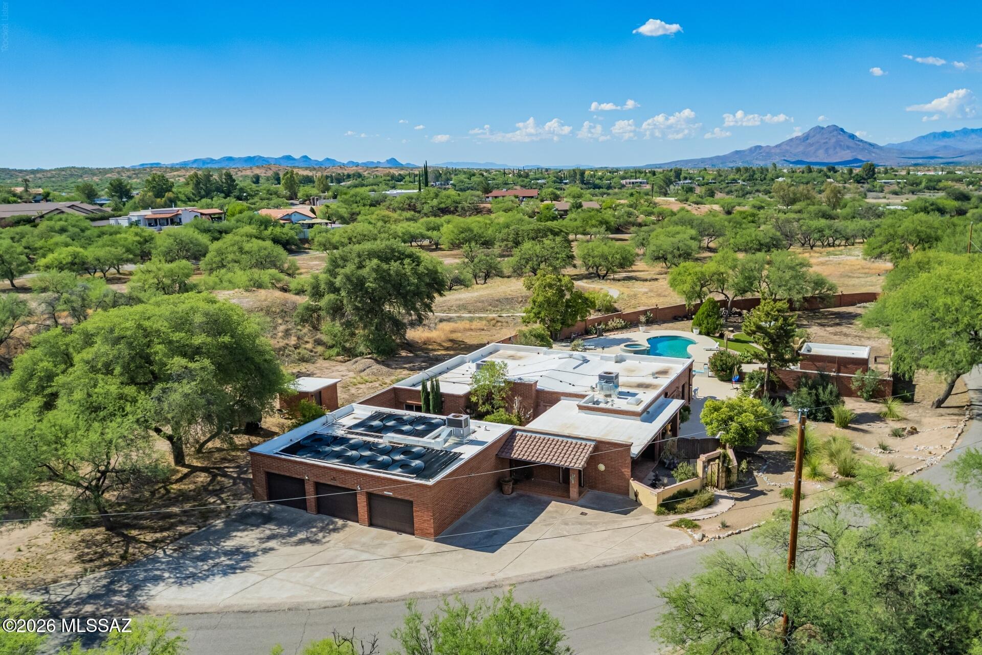 Seller will accept or counter offers priced between $549,900-559,900. Located in the highly sought-after Meadow Hills neighborhood of Nogales, this exceptional custom estate offers an unmatched combination of space, functionality, and resort-style living on 1.4 acres with no HOA. Designed for both entertaining and everyday comfort, the home features 3 bedrooms, 2.5 bathrooms, a dedicated office/den with private entrance, multiple living areas, and a gas fireplace. Car enthusiasts and hobbyists will appreciate the extended-length 3-car garage with its own HVAC system, detached workshop, abundant storage, full RV hookups, and whole-house generator. The backyard is a true retreat, showcasing a heated pebble-finish pool and spa powered by gas and solar, covered patio, gazebo, artificial turf, dog run, mature landscaping, and breathtaking mountain views. A detached storage building with electricity, water, and sink offers additional flexibility for hobbies, projects, or equipment storage. Additional highlights include 3 HVAC systems, 3 water heaters, commercial-grade roofing, a charming courtyard garden, and extensive storage throughout. A rare Meadow Hills property offering versatility, privacy, and amenities seldom found in today's market.