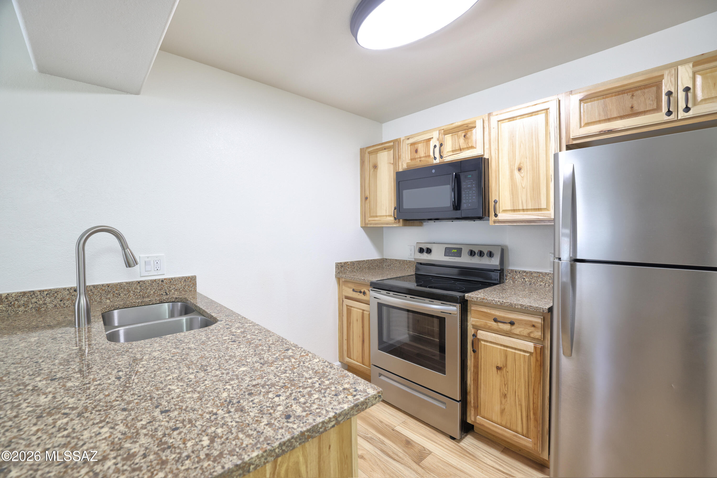 Move-in ready corner-unit condo in the gated Veranda at Ventana community! This well-maintained 1-bedroom, 1-bath home offers easy, low-maintenance living with fresh interior paint, wood flooring, updated cabinetry and stainless steel appliances. Relax on the private balcony overlooking wonderful landscaping with pleasant pool and mountain views, creating a peaceful outdoor space. Residents enjoy two community pools, a fitness center, and beautifully maintained common areas. Ideally located in the Catalina Foothills area of Tucson, just minutes from world-class hiking, golf, shopping, dining, and all the outdoor recreation the area has to offer. A perfect full-time residence, seasonal retreat, or lock-and-leave home. Call for an easy showing!