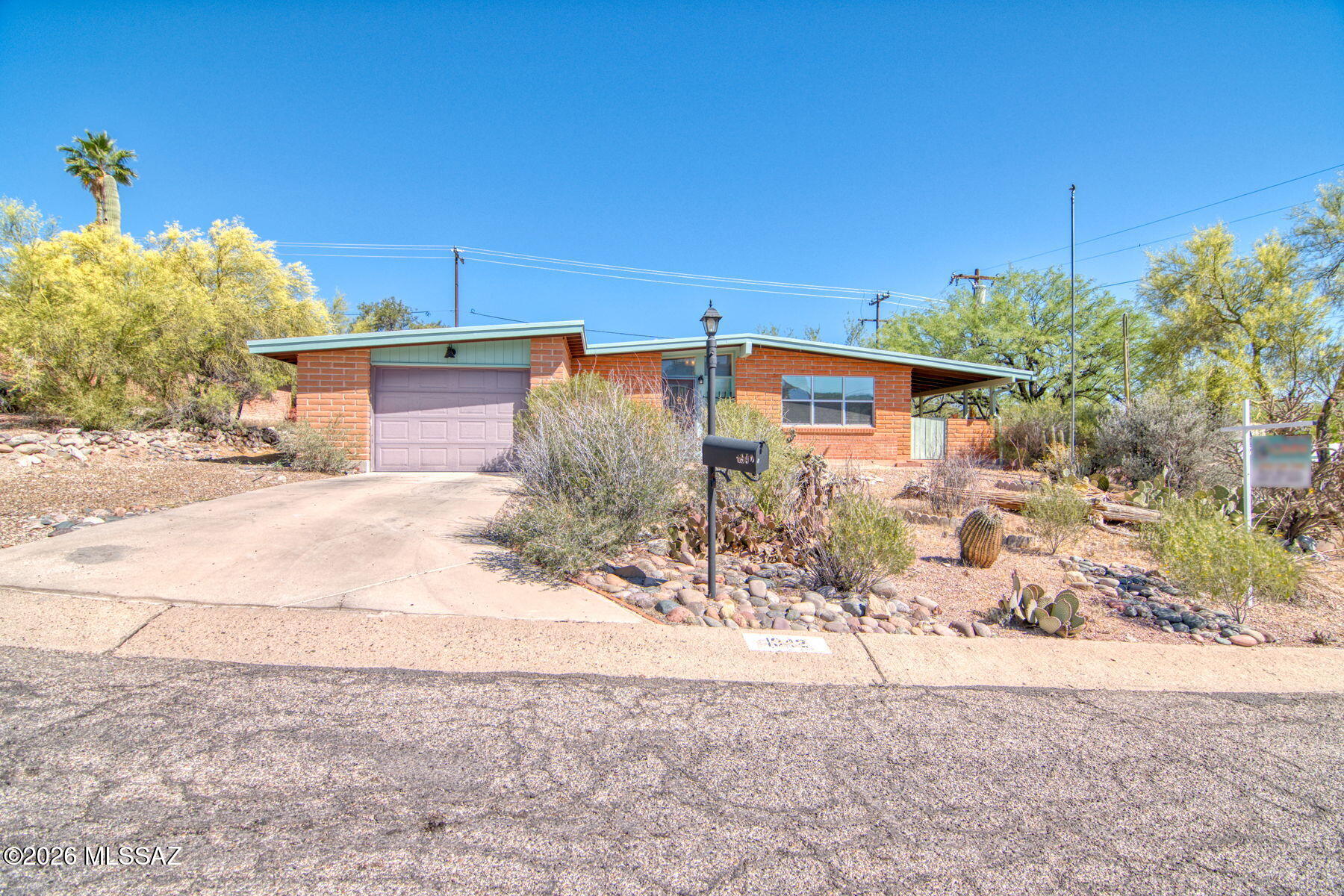 Perched on an elevated lot in Tucson's desirable Westwood Hills, 1942 W Calle Placida blends authentic mid-century character with inviting everyday livability. Built in 1961 of traditional burnt adobe masonry, this 3-bedroom, 2-bath home offers 1,306 square feet, a charming updated kitchen, separate laundry room, one-car garage, and wonderful patio positioned to capture the sweeping desert and city views. Inside, the guest bath and primary shower retain the vintage appeal buyers love, while the home's warm architectural style feels distinctly Tucson. Ideally located with convenient access to downtown, the UofA, I-10, Pima Community College West, Tumamoc Hill, and Tucson Mountain Park, his is a rare chance to own a Sonoran Desert classic with character, location, and potential.
