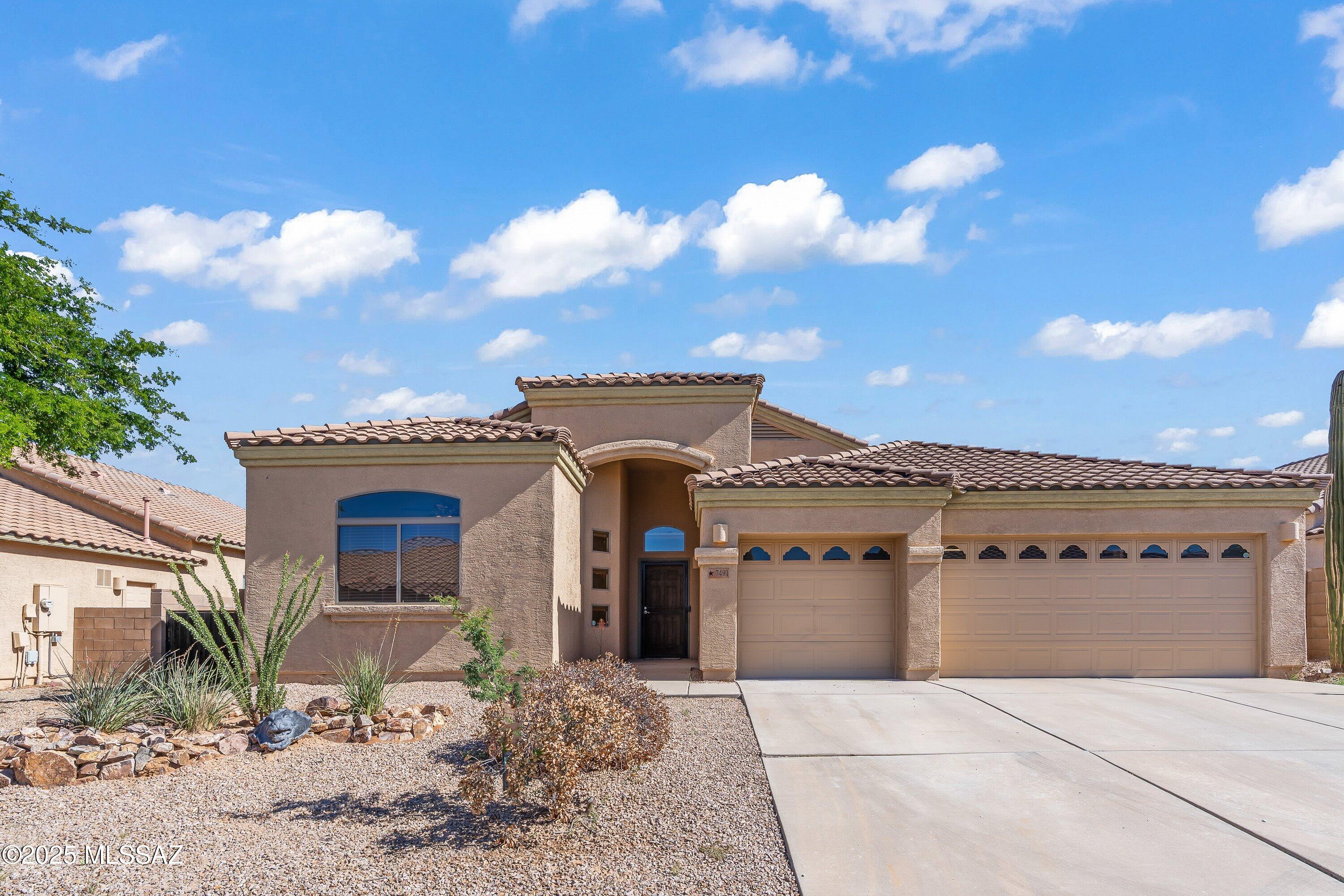 Welcome to this spacious 4-bedroom, 2-bath home in the Star Valley community of Tucson. Offering 2,338 sq ft, this residence features high ceilings, a split bedroom layout, and an inviting living room. The kitchen is equipped with black appliances, pull-out cabinets, new garbage disposal (Nov. 2025) and connects easily to the dining area and bonus den/office. The primary suite includes a walk-in closet, double vanity, soaking tub, and shower. Outside, enjoy a 3-car garage, covered patio, and a large backyard with no rear neighbors—bordering open tribal land for unobstructed desert and mountain views. Community perks include a park, basketball court, and dog park, with easy access to I-10, I-19, shopping, dining, and more.