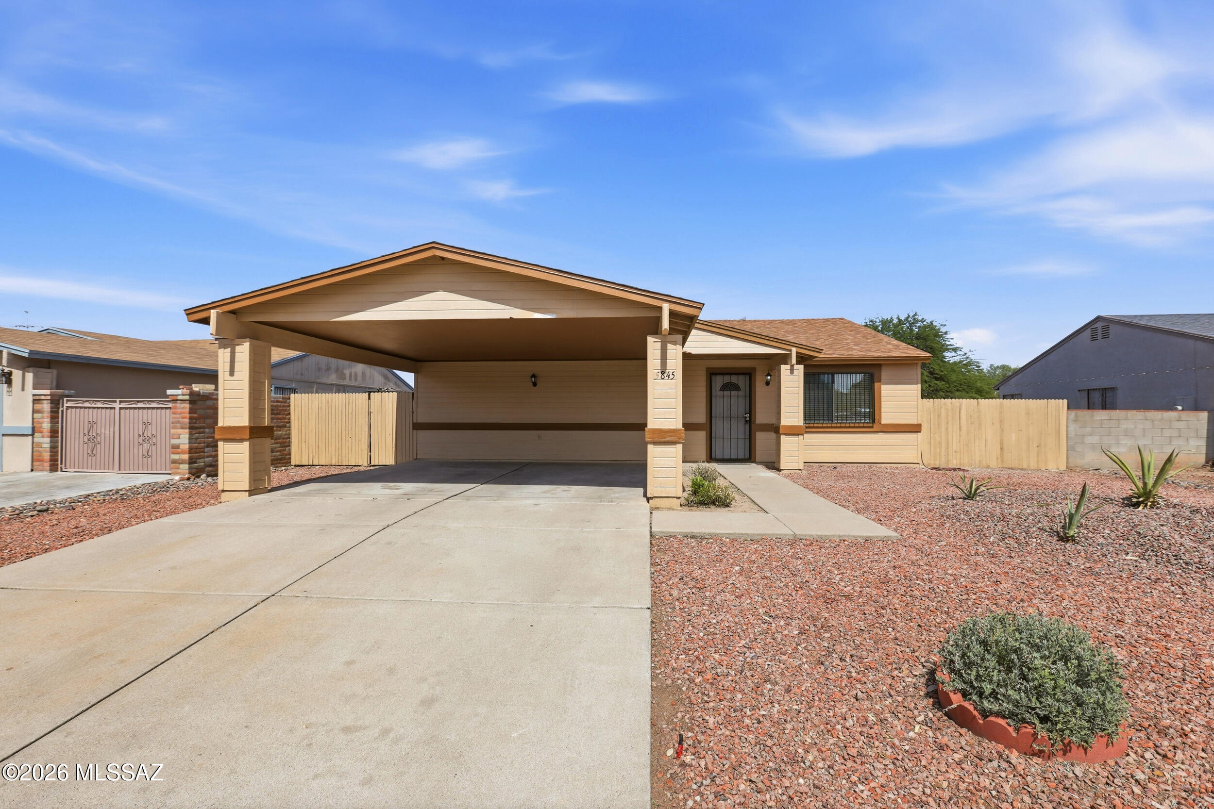 Welcome to this beautifully maintained 3-bedroom, 2-bath home in the desirable Midvale Park community! Offering approximately 1,400 sq. ft. of living space, this inviting residence features a spacious open-concept layout with multiple living areas, perfect for entertaining and everyday living. The well-appointed kitchen boasts abundant cabinetry, ample counter space, and a functional island overlooking the main living area. Enjoy tile flooring throughout, ceiling fans, a split-bedroom floor plan for added privacy, and a generously sized primary suite. Step outside to a covered patio and expansive backyard ideal for gatherings, pets, or relaxing Arizona evenings. Conveniently located near parks, schools, shopping, dining, and easy access to major commuter routes. A must-see opportunity!