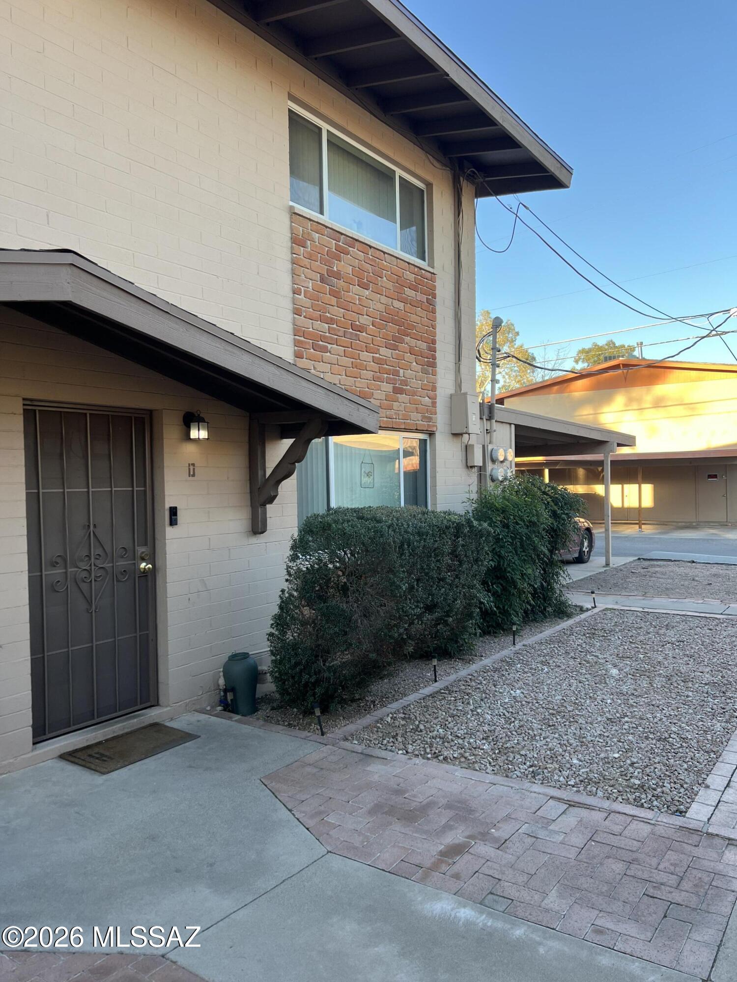 This well-kept condo is perfect for a first time home buyer, small family, single person or couple! Bedrooms are upstairs with a Jack & Jill style bathroom and large walk-in closets. Kitchen looks out into the private back yard and this unit already has a refrigerator, washer and dryer. Close to U of A, restaurants or shopping. HOA maintained landscaping, roof and street. Extra storage room in carport for all those seemingly important items you may need one day! There is a community pool and recreation building for large gatherings. Don't miss out on this one, priced to sell.