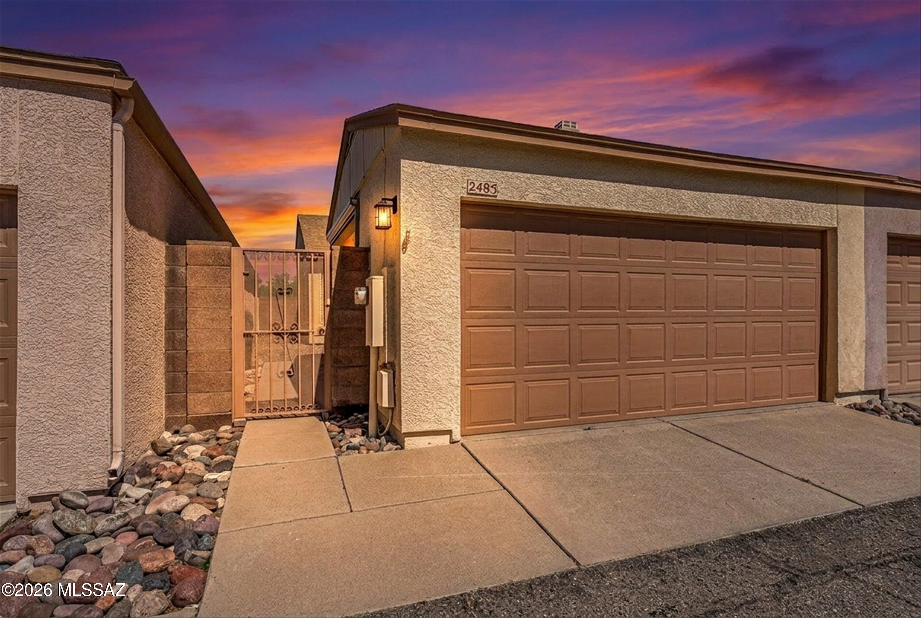 Nestled at the quiet end of a street in the highly coveted Casitas de Palo Santo community, this pristine 905-sqft Townhome offers a rare combination of sophisticated updates and genuine warmth. From the moment you arrive at this adorable gated enclave, you are greeted by a sense of security and a clear pride of ownership that carries through every corner of the property. Your journey begins in the spacious and private gated front courtyard, leading to a two-car garage that is uniquely equipped with dual Sunesta remote-controlled shades to keep your space dust and critter-free. Shimmering new Low-E windows hint at the home's excellent energy efficiency even before you step through the front door.