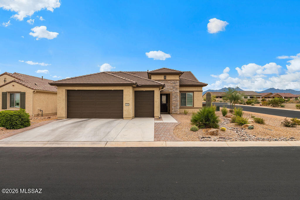 Welcome to luxury living in the highly sought-after 55+ community of Quail Creek. This stunning home showcases top-of-the-line upgrades throughout with no expense spared.

From the moment you step inside, you'll notice the attention to detail--plantation shutters, recessed lighting, luxury vinyl flooring, crown molding, high baseboards, and soaring 11-ft ceilings create an elegant and inviting atmosphere. The thoughtfully designed split floor plan offers privacy, with a luxurious primary suite featuring a beautifully tiled walk-in shower and custom closet system, while the guest bedroom enjoys its own private full bathroom with a tiled shower/tub combo.

At the heart of the home is a gorgeous, high-end kitchen complete with upgraded cabinetry, soft-close drawers, walk-in pantry, and premium finishes--perfect for both everyday living and entertaining. Just beyond, you'll find wall-to-wall built-in cabinetry with a wet bar and wine fridge, adding both function and sophistication.

Situated on a corner lot near the Canyon Club, this home offers peek-a-boo mountain views and a beautifully designed outdoor space featuring a covered patio, motorized shades, outdoor TV mount, and an extended paver patio--ideal for enjoying Arizona's stunning sunsets.

The epoxy-coated garage includes a water softener system, rounding out this meticulously upgraded home that truly has it all.

Enjoy resort-style amenities including golf, pools, fitness center, pickleball, and endless social activities--all part of the Quail Creek lifestyle.