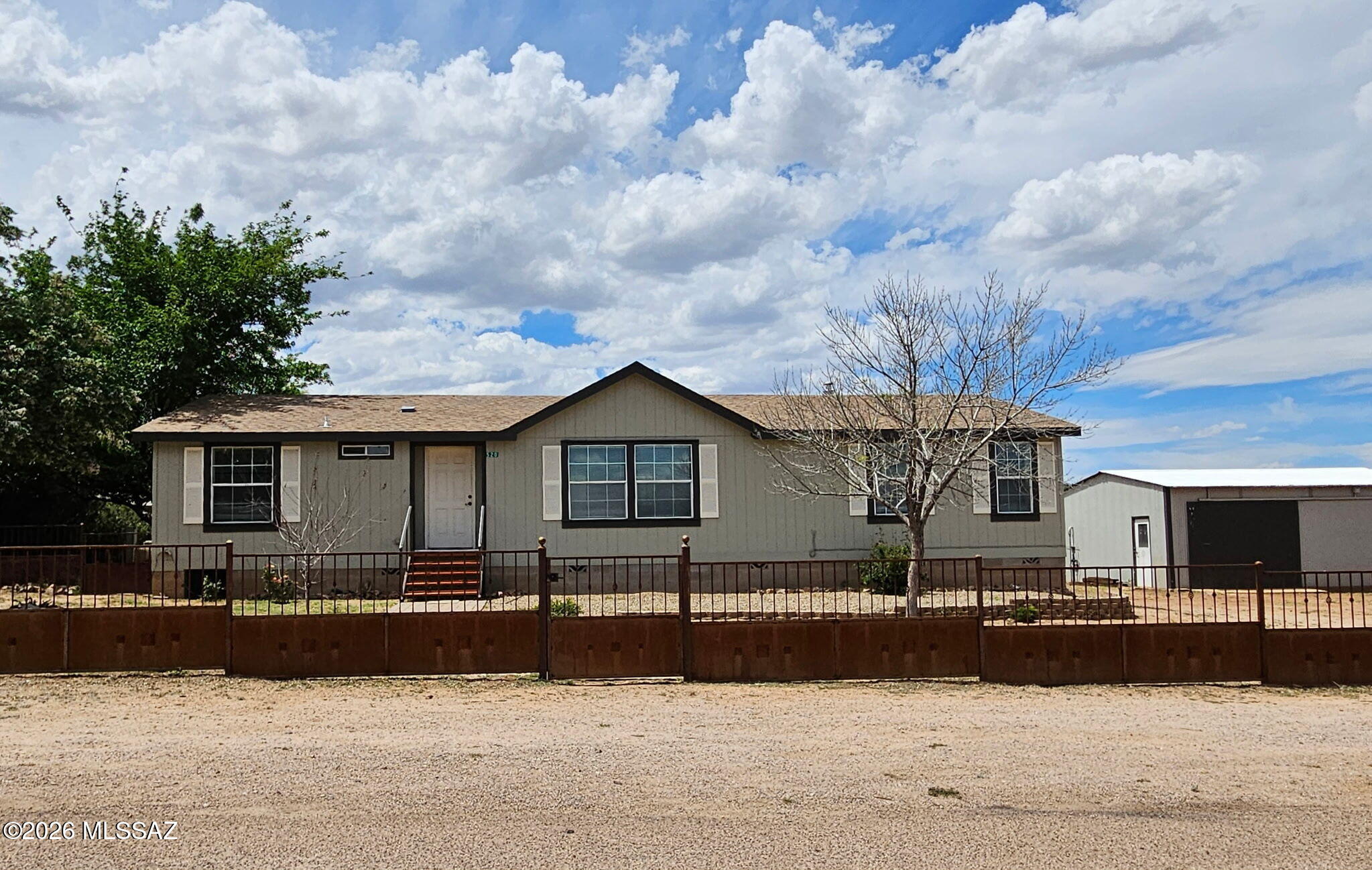 This well maintained, move-in ready home has everything you need!  The 2007 2,048 sq. Ft. 3 bed/2 bath Cavco home has an open and bright split floorplan. New carpet throughout.  The generous sized lot is completely fenced. A custom welded fence is across the front of the property w/a gated entrance & divides the front & backyards. Mature trees offer plenty of shade.  Storage shed w/loft for hobbies, workshop or additional storage.  The 24' x 30' garage/shop has water & 100 Amp service w/220 as well as an additional 50 Amp service.  Mountain views. Easy access to I-10 for commuting. Come take a look today!