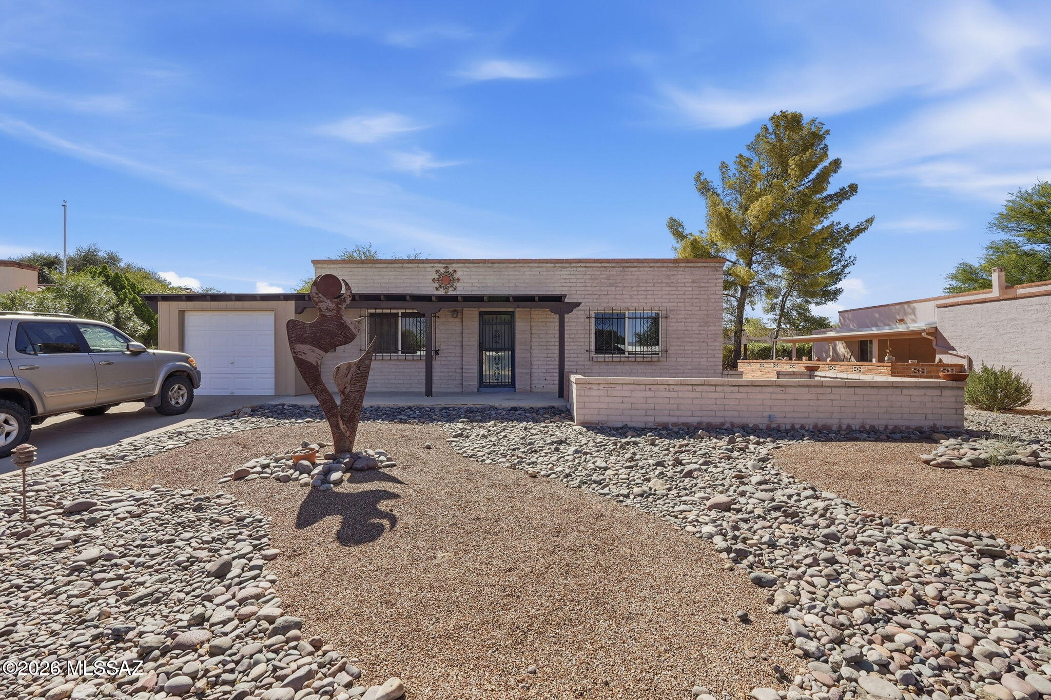 Comfortable home located in a low traffic cul-de-sac with gorgeous sunrise and mountain views, plus an unbeatable Green Valley location! Enjoy morning coffee from the front porch while taking in the stunning mountain backdrop. The home offers a 1-car garage plus an attached storage area behind the garage, providing plenty of room for a studio, hobbies, tools, or extra belongings. Several newer windows and a newer sliding glass door have already been added, giving the next owner a great head start on future updates. Conveniently located near I-19, grocery stores, restaurants, shopping, and everyday services. As part of  GVR, you can enjoy access to 13 recreation centers featuring hundreds of clubs, classes, activities, pools, fitness facilities, and social opportunities.