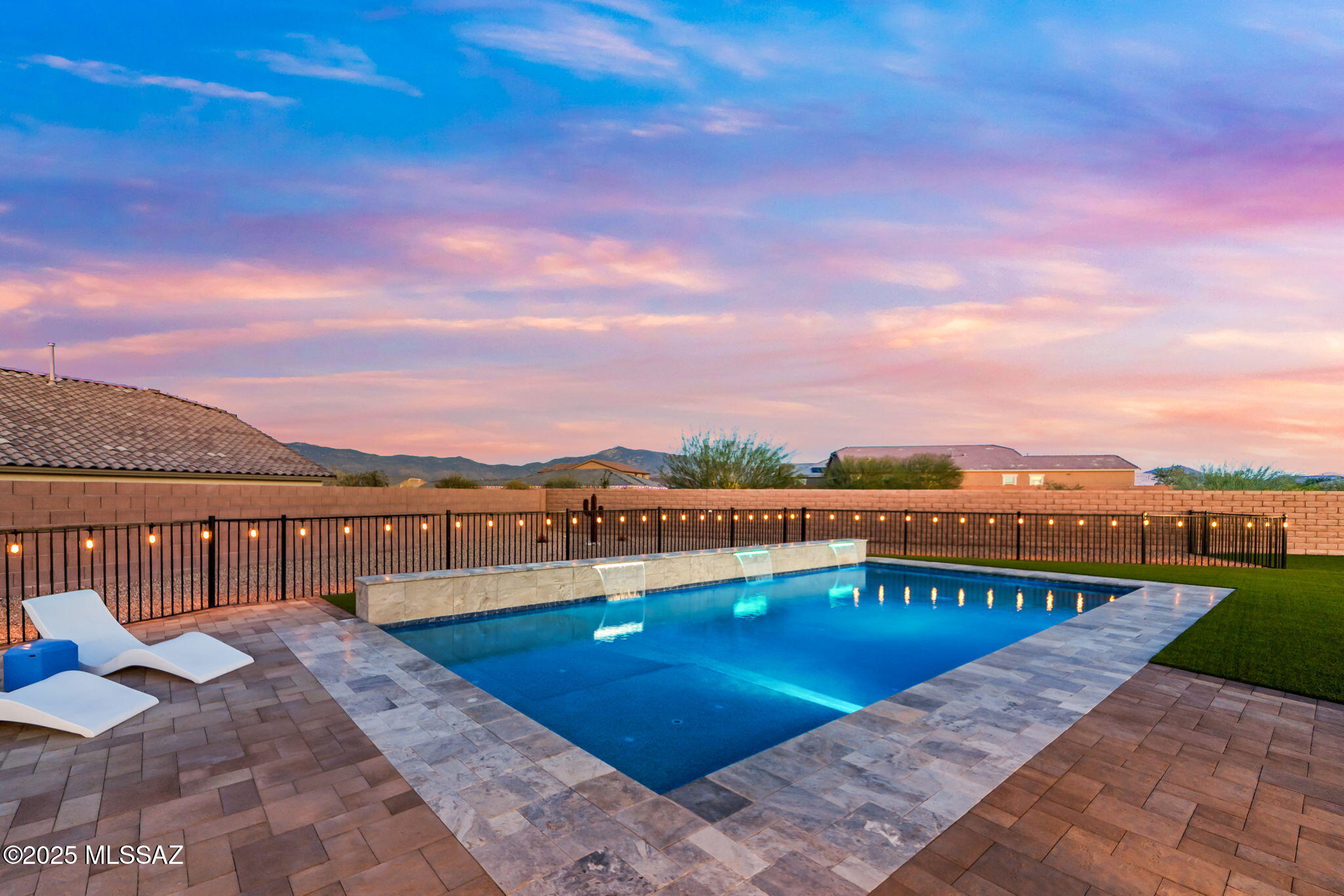 Welcome to this 2024-built home in Rocking K, tucked on a quiet cul-de-sac with an oversized lot offering privacy and breathtaking mountain views. This four-bedroom, three-bath home features modern finishes and a functional layout. The backyard feels like a private resort, with a pool, paid-off solar, extended covered patio, fully equipped outdoor kitchen, large turfed areas, and a fenced cactus garden. The HOA has approved an additional gazebo, adding even more potential. An extended paver driveway provides extra parking and curb appeal. Rare in Rocking K, this nearly new home combines style, upgrades, and ultimate Arizona outdoor living. This home also features an extended paver driveway and a beautifully pavered patio, adding both style and functionality to the property. Rocking K is a highly desirable master-planned community with abundant parks, biking and walking trails, and activities for all ages.