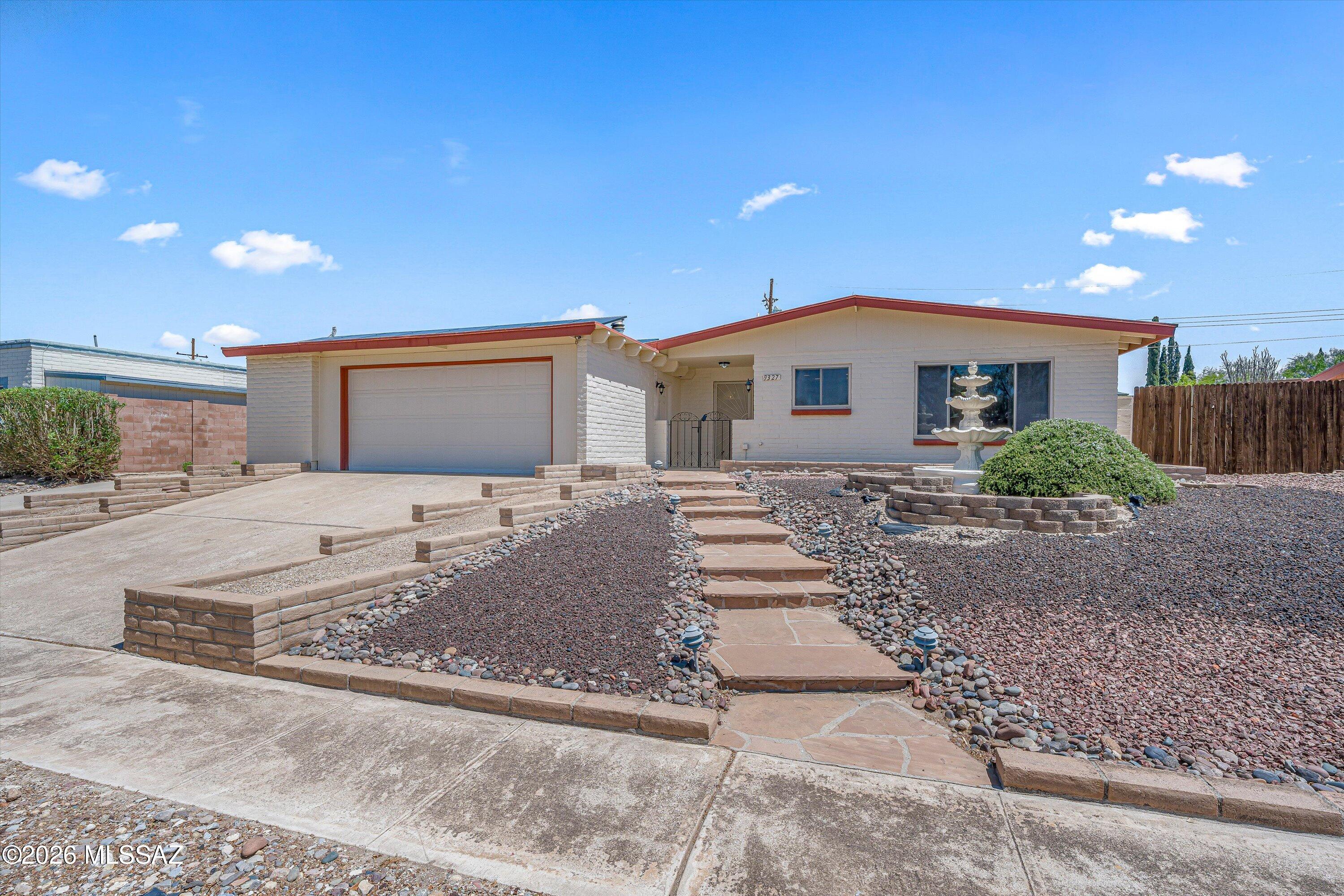 PAID OFF Solar! Beautiful 3BED/2BATH brick home with POOL & SPA in East Tucson. The front yard features low maintenance desert landscaping, a spacious driveway, and a charming stone walkway leading to the entrance. Inside you'll find beautiful ceramic flooring throughout. The kitchen offers warm wood cabinetry and stainless steel appliances. The spacious and comfortable primary suite features a cozy wood burning fireplace and an ensuite bathroom with a walk-in shower. Step outside to your private backyard retreat with a sparkling pool and spa, perfect for relaxing or hosting family and friends all year long. The two car garage also includes a large storage room. Don't miss the opportunity to make this gem your own!