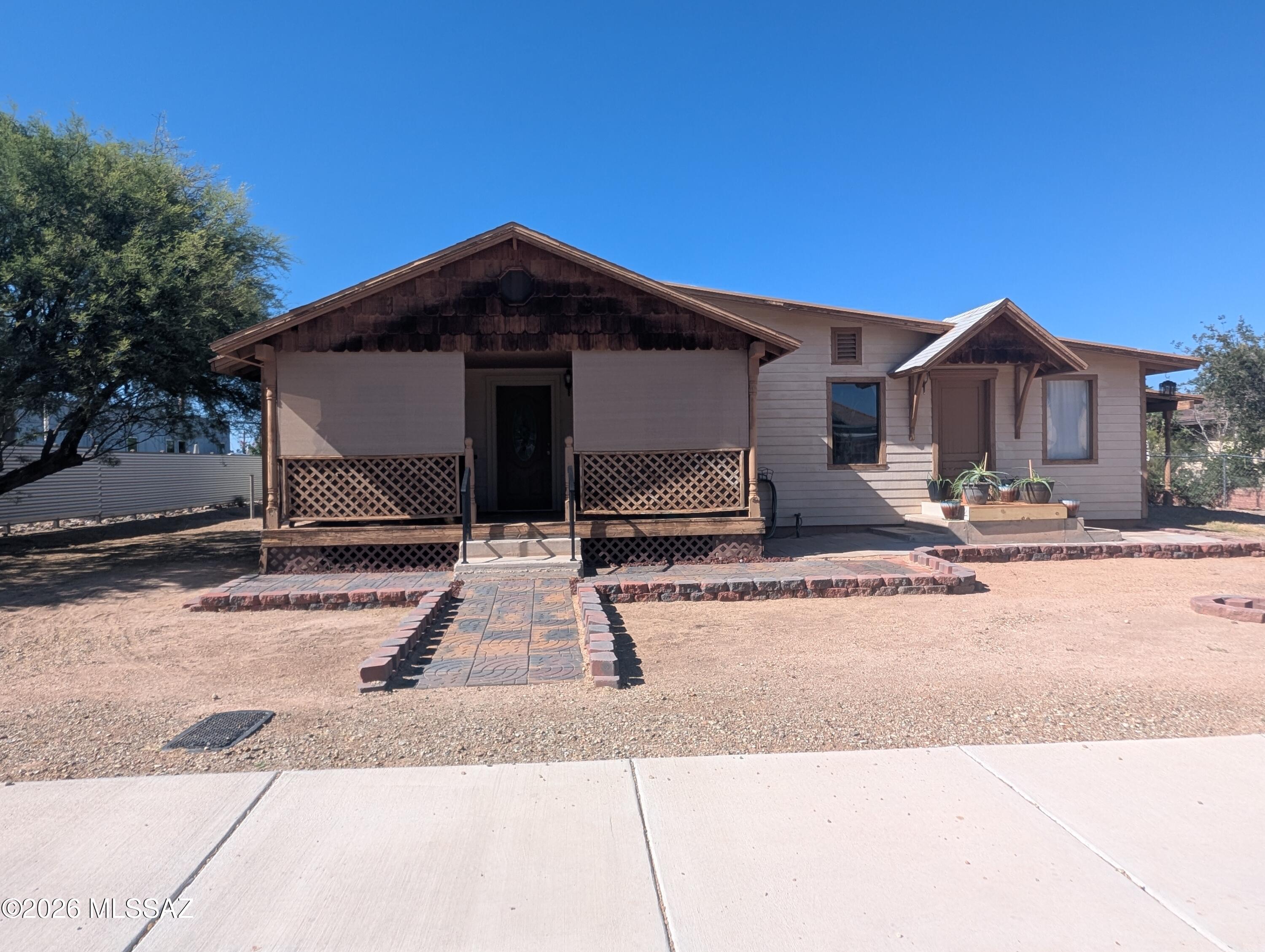 Charming home with great curb appeal and a large detached garage! The inviting covered porch and attractive wood accents give this property a warm Southwestern feel. Situated on a spacious lot with low maintenance landscaping, there's plenty of room for hobbies or outdoor activities. The detached garage offers endless possibilities and has a 1/2 bath for added convenience. Come see this great opportunity for buyers searching for comfort, functionality and extra space!