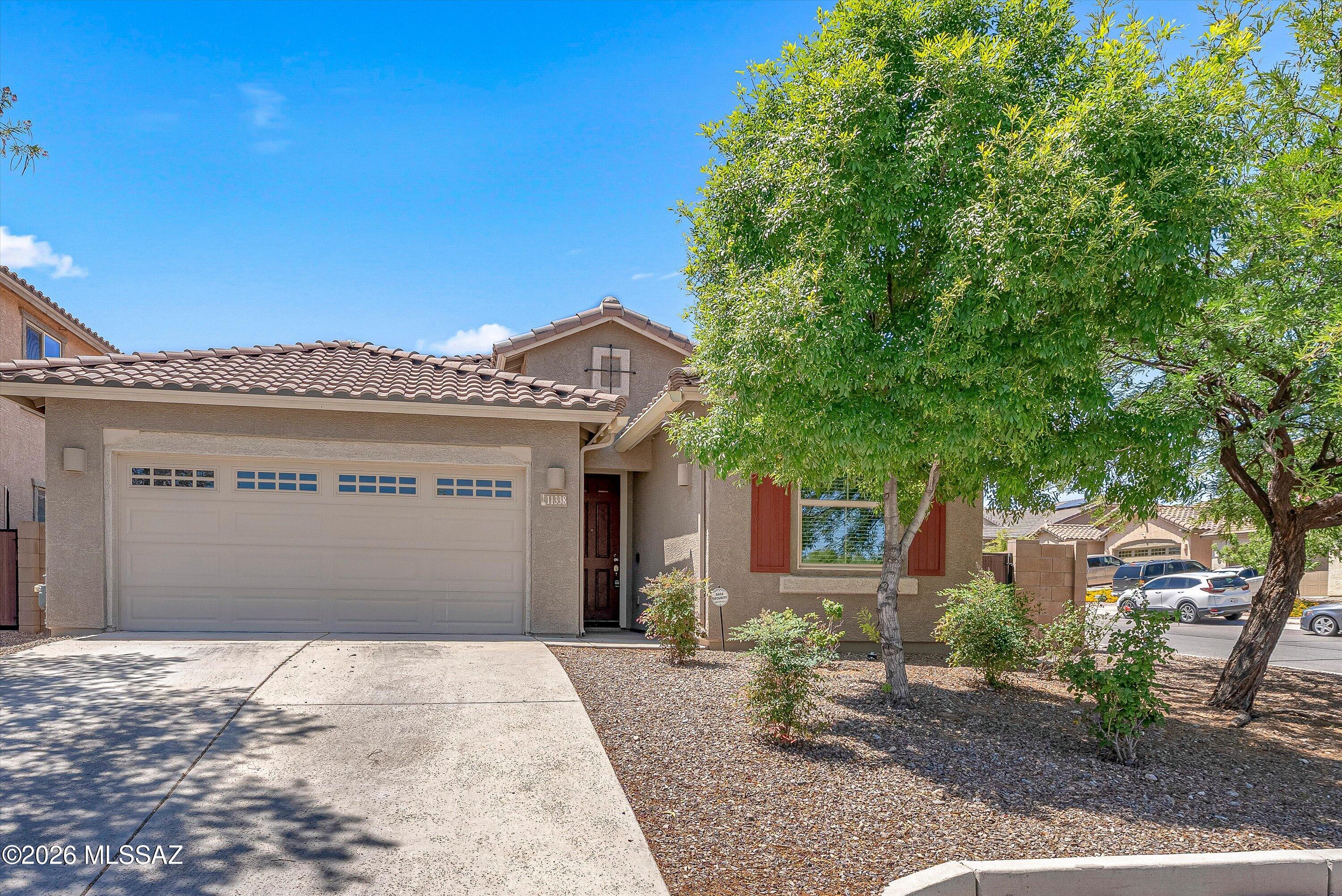 Located within the award-winning Vail School District, this beautifully maintained home offers the perfect combination of comfort, style, and outdoor living. Situated on a premium corner homesite, the property enjoys added privacy, & a peaceful neighborhood setting. Step inside to an inviting open-concept layout highlighted by soaring vaulted ceilings, abundant natural light & spacious living areas. The kitchen seamlessly connects to the great room & dining area, creating a welcoming atmosphere throughout the home. The backyard is truly a standout feature and designed for year-round Arizona living. Enjoy relaxing evenings under the expansive custom gazebo w/ a fully paved patio area ideal for outdoor dining, gatherings, or simply unwinding in the shade. Click ''more' The thoughtfully landscaped yard offers low-maintenance desert beauty, mature trees, and plenty of open space for entertaining and play. A charming play structure adds even more versatility to the outdoor space, while the elevated rear wall enhances privacy and creates a serene retreat-like setting. Additional highlights include stainless steel appliances, oversized tile in the main living areas, spacious laundry room, a generous 2-1/2 car garage with ample storage. Conveniently located across from a pocket park and close to schools, shopping, dining, DMAFB, major employers and the I-10 Fwy, this home offers exceptional value in one of Tucson's most sought-after southeast communities.