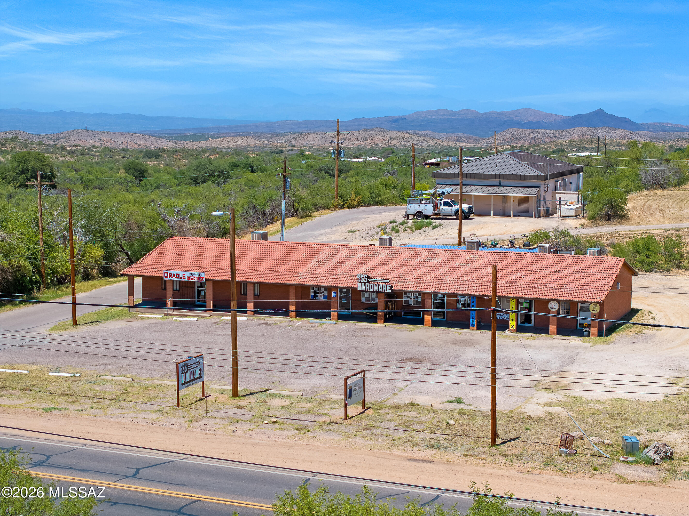 Fully leased multi-tenant retail/commercial investment opportunity in Oracle with stable in-place income and future upside potential. The property consists of approximately 3,060 SF across five individually metered suites with 20 on-site parking spaces and excellent main road frontage offering strong visibility and signage exposure.

Diverse tenant mix includes SSS Hardware Store, local gym, craft retail, & aesthetic services. SSS Hardware occupies Units B & C (1,200 SF combined) with lease secured through mid-2029, providing long-term tenancy stability, while shorter-term leases in remaining suites offer future rental growth opportunities.
• Unit A - 1,200 SF | Gym | $660/month
• Units B & C - 1,200 SF combined | SSS Hardware | $1,000/month | Unit D - 300 SF | $350/month Unit E - 300SF/ $350/moth. More photos on the updated interiors to come. Legal description to convey does not reflect legal description shown on accessors map, Portion of Ray road From lot 10-19 are not part of sale.  Acreage & zoning to be verified.