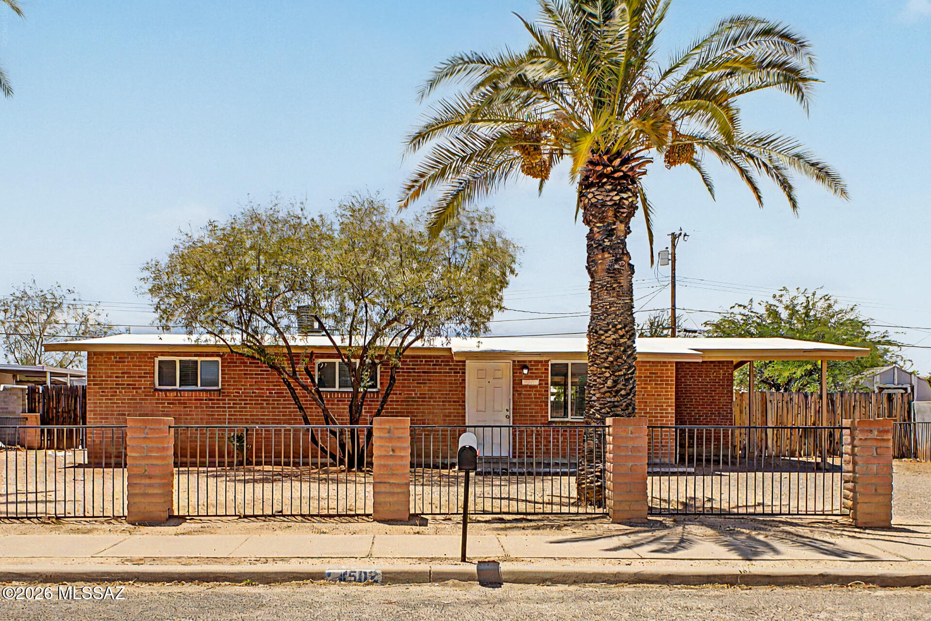 No HOA, solid brick construction, and room to grow! Set on an oversized 8,293 sqft lot, this well-maintained home offers classic character with endless possibilities. Inside, you'll find a clean, inviting interior with neutral paint, tile flooring throughout, and a bright kitchen featuring white cabinetry and appliances. Step outside to enjoy the large covered patio overlooking a spacious backyard shaded by mature trees--perfect for relaxing, entertaining, or bringing your dream outdoor space to life. With a low-maintenance front yard and ample room to add a pool, garden, workshop, or future expansion, this property offers incredible flexibility. Whether you're looking for your first home, an investment, or a place to make your own, this timeless gem is ready for its next chapter.