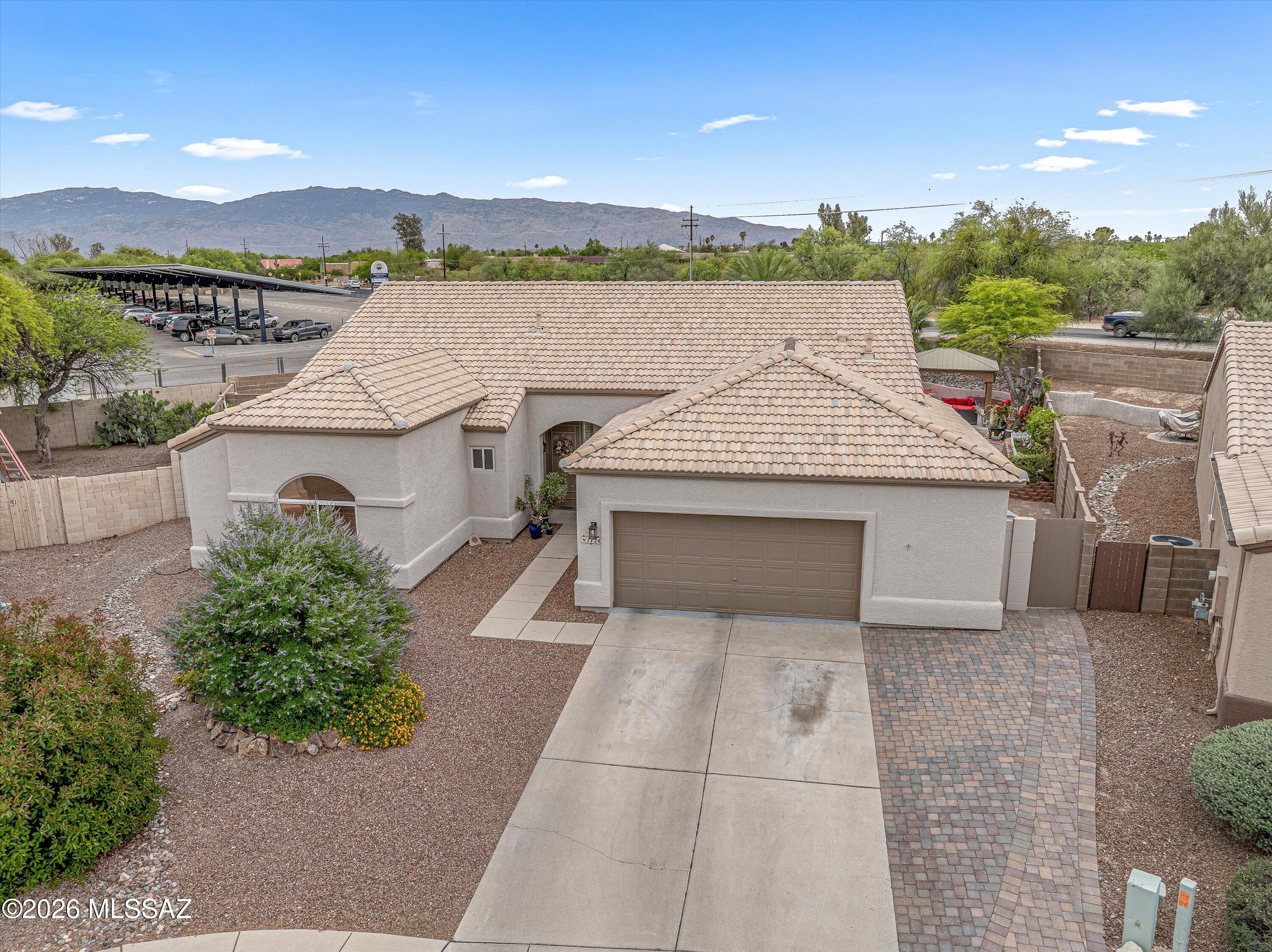 Located in the gated Sierra Linda subdivision, this beautifully maintained home offers the perfect combination of comfort, style, and stunning desert scenery. Inside, you'll find an open and inviting floor plan filled with natural light, and spacious living areas.

The kitchen is designed for both everyday living and entertaining, featuring ample cabinetry, generous counter space, and a seamless connection to the dining and family rooms.

Step outside to your own backyard paradise featuring a sparkling pool perfectly positioned to capture breathtaking mountain views and Arizona's unforgettable sunsets. Whether hosting friends, enjoying a quiet evening swim, or simply relaxing under the desert sky, this outdoor space delivers the ultimate Tucson lifestyle! The private primary suite serves as a relaxing retreat with a spacious layout and well-appointed bath, while additional bedrooms provide flexibility for guests, a home office, or home gym. Home has thoughtful upgrades throughout, including plantation shutters on every window, upgraded kitchen, builtin pantry with sliding drawers, and so much more! 

Conveniently located near shopping, dining, parks, and easy access to major roadways, this move-in ready home offers the ideal blend of neighborhood charm, and spectacular scenery.

Take ease and comfort with the roof being replaced in the last 3 years and the AC unit being 2 years old. Book your showing today!