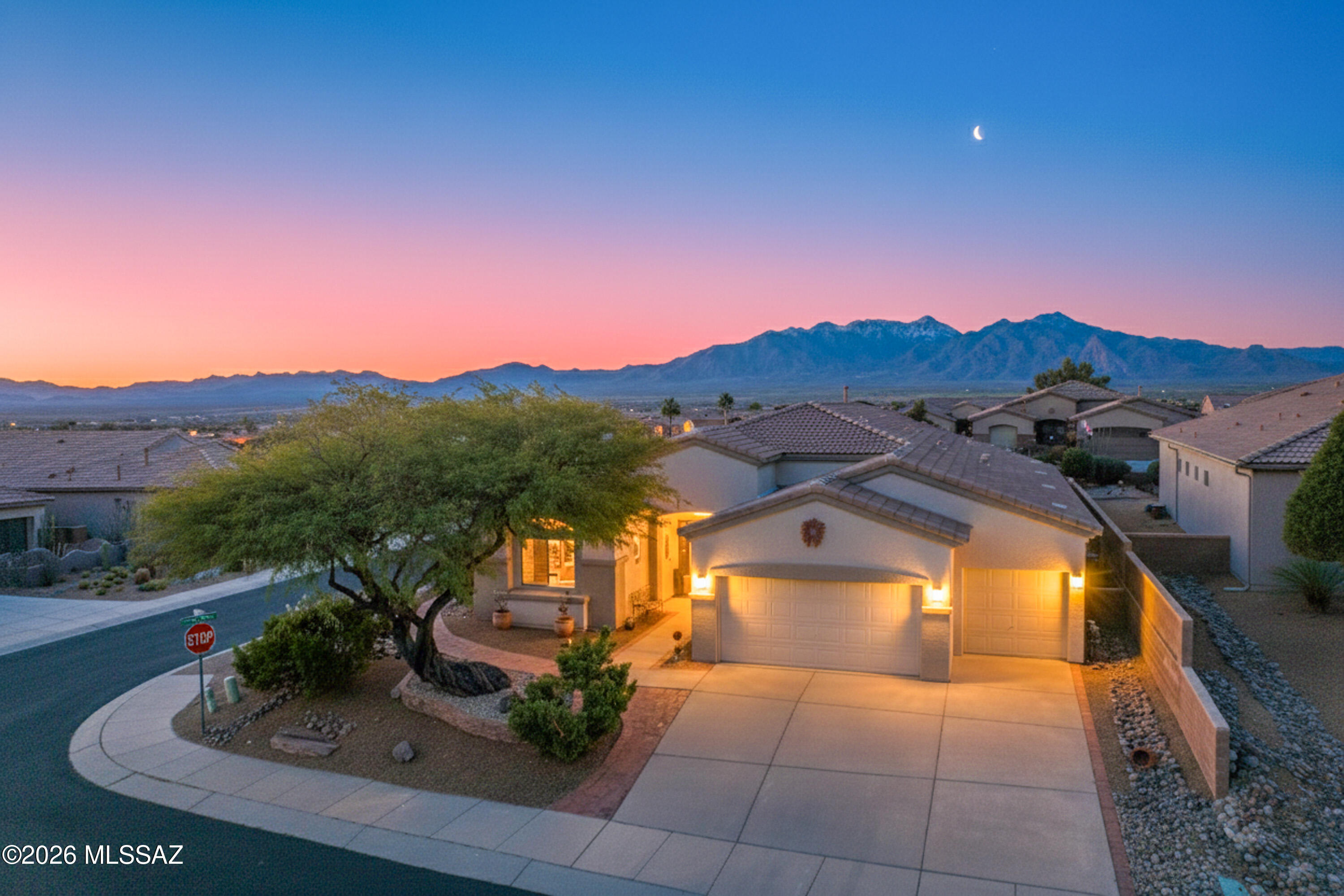 This move-in ready home combines comfort, efficiency, and stunning surroundings. Major upgrades include a full roof replacement, newer two-stage AC for energy savings, and a newer water heater. Upgraded appliances include refrigerator, washer, and dryer. The primary suite features a fully remodeled bathroom with a custom tiled walk-in shower. The kitchen is enhanced with granite countertops, SS double-oven range, and a large pantry. The great room provides mountain views and a beehive fireplace, for cozy evenings. A three-car garage provides ample storage with cabinets and overhead racks. Set on a large corner lot with sweeping mountain views, the backyard oasis is complete with a calming rock fountain. Enjoy warm, sun filled winters, with all the GVR activities in this  Green Valley home