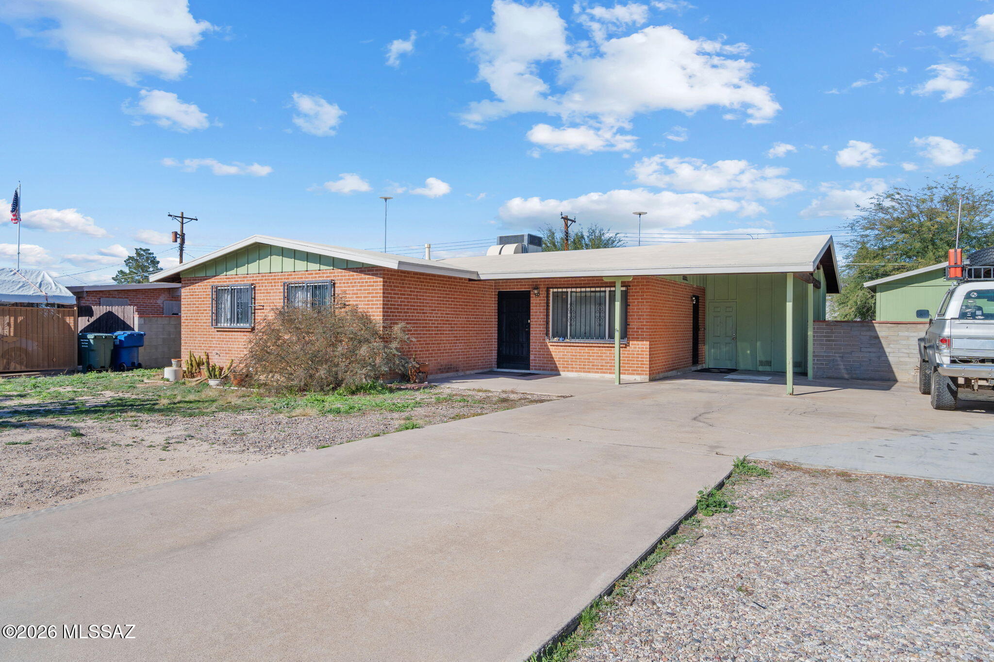 This inviting 3-bedroom, 2-bath brick home in Tucson's Terra Del Sol neighborhood features a freshly painted interior and offers 1,240 square feet of comfortable single-level living on an 8,102 square foot lot with no HOA. A cozy living room, ceramic tile and carpet flooring, and a practical layout create an easy everyday flow, with the kitchen opening to the living area and an additional storage room providing extra flexibility. Outside, a covered patio, mature landscaping, and a spacious workshop ideal for tinkering or projects add valuable functionality, while a covered carport with extra parking, central air and a heat pump with natural gas heating, block fencing for privacy, mountain views, and wrought iron security accents round out the home's appealing features.