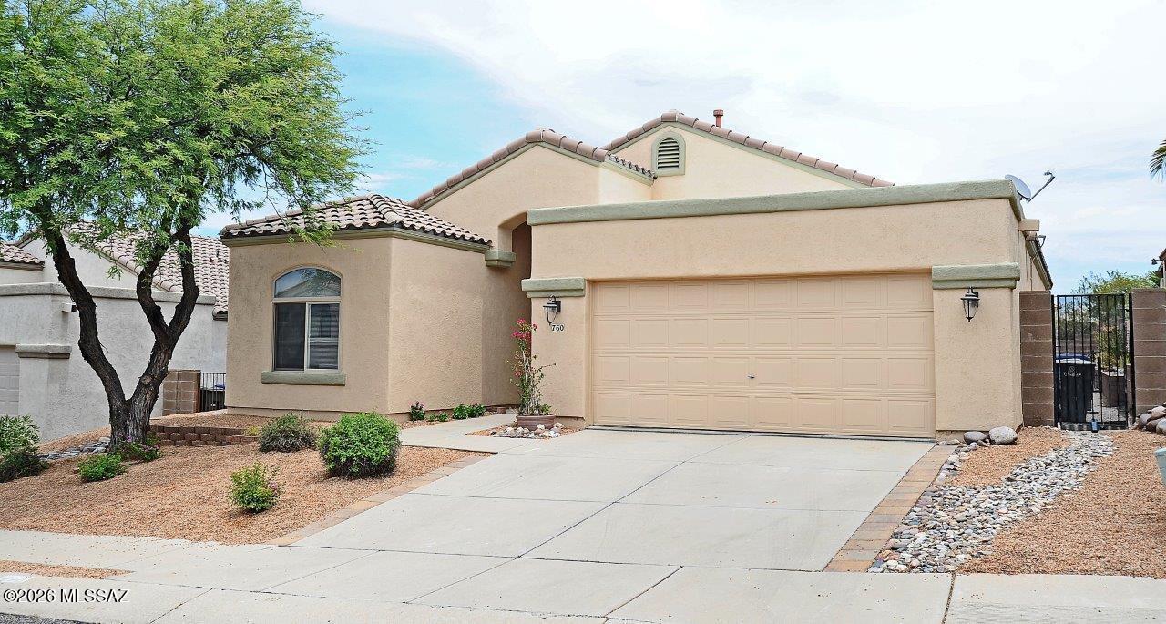 Welcome to your desert oasis in the highly sought-after Silverado Hills subdivision.  This stunning 1,622 sq. ft. single-story home perfectly blends modern upgrades with an outdoor paradise designed for entertaining and plant enthusiasts alike.  From the new two-tone interior paint that includes the garage to the energy efficient solar system on the classic tile roof, every detail of this property has been meticulously cared for.  Step inside to an expansive Great Room featuring vaulted ceilings with a ceiling fan.  The main living areas have a ceramic wood-look floor tile that combines rustic charm and easy maintenance.  Just off the Great Room, the sesignated dining area is perfect for hosting dinner parties, complete with elegant chandelier lighting and built-in decorative cabinets. The bright functional kitchen is a home chef's dream, featuring plenty of granite countertops with ample prep space, an abundance of pull out self closing cabinetry for all your storage needs, stainless steel appliances, and a cozy breakfast nook for casual morning coffee.  Designed for maximum privacy, the split-bedroom floor plan ensures everyone has their own space.  The Primary Suite off the Great Room is a peaceful retreat featuring a gorgeous view of the backyard and access to the covered patio.  The en-suite primary bath offers the untimate relaxation setup with a separate shower and soaking tub, alongside a spacious, carpeted walk-in closet.  Two additional bedrooms sit on the opposite side of the home.  The middle bedroom features elegant glass doors, making it the perfect flex space for a dedicated home office, den, or library.  Step throught the kitchen or Great Room to the East facing covered back patio with an extended white pergola with decorative lighting, and beautiful flagstone pavers leading from the freshly painted patio floor.  The large low maintenance back yard has a raised block flower and plant bed with a convenient drip irrigation system. This home is conveniently located close to shopping, dining, and outdoor recreation.