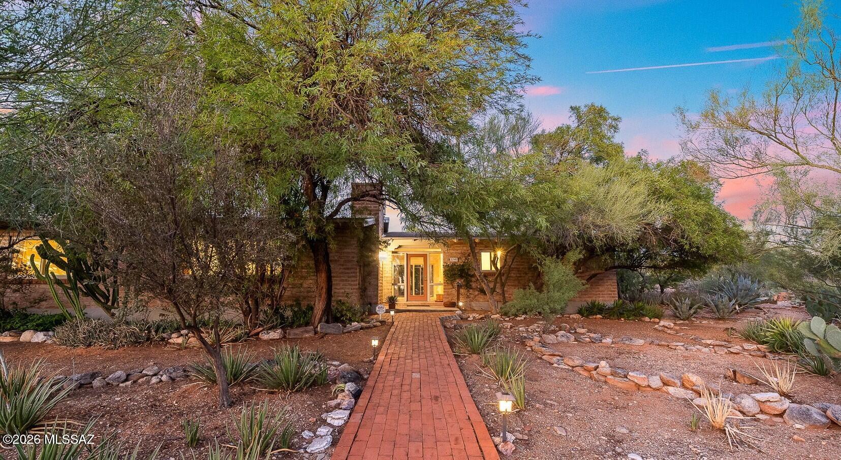 Nestled in the highly sought-after Foothills, this charming 3-bedroom, 2-bath home sits on a spacious one-acre corner lot surrounded by natural desert beauty. Inside, the well-designed floor plan balances comfort and functionality, highlighted by retro-style bathrooms with vintage flair and Saltillo flooring that adds character and charm. A cozy wood-burning fireplace creates a warm gathering space, while clerestory windows and a wall of sliding glass doors fill the home with abundant natural light and provide a stunning backdrop of the desert landscape. Outdoors, the front and back yards feature natural desert surroundings, offering a private setting in harmony with nature. BRAND NEW ROOF & SEPTIC TANK INSTALLED.. Pergola beams were removed to provide unobstructed mountain views!