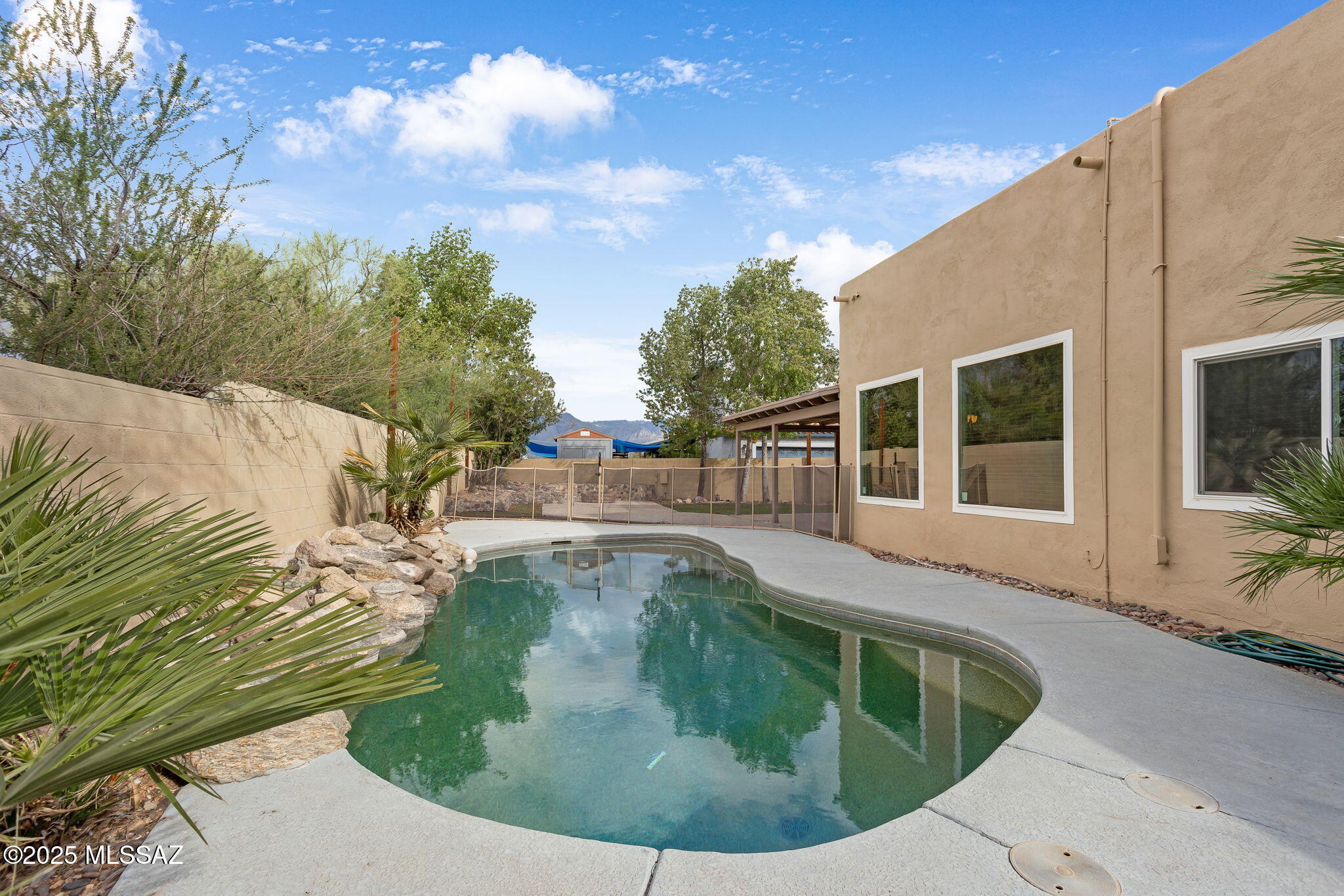 Pool and NO HOA!  Great Eastside location and on a cul de sac! Both the exterior and interior of home have just been painted. The backyard is ideal for entertaining, featuring a Pebble Tec pool next to a wrap-around back patio with a large deck and fire pit. The home itself has an open floor plan with a large great room and three bedrooms. There is tile and wood laminate flooring throughout, and patio access is available from the kitchen, dining area, and primary bedroom.