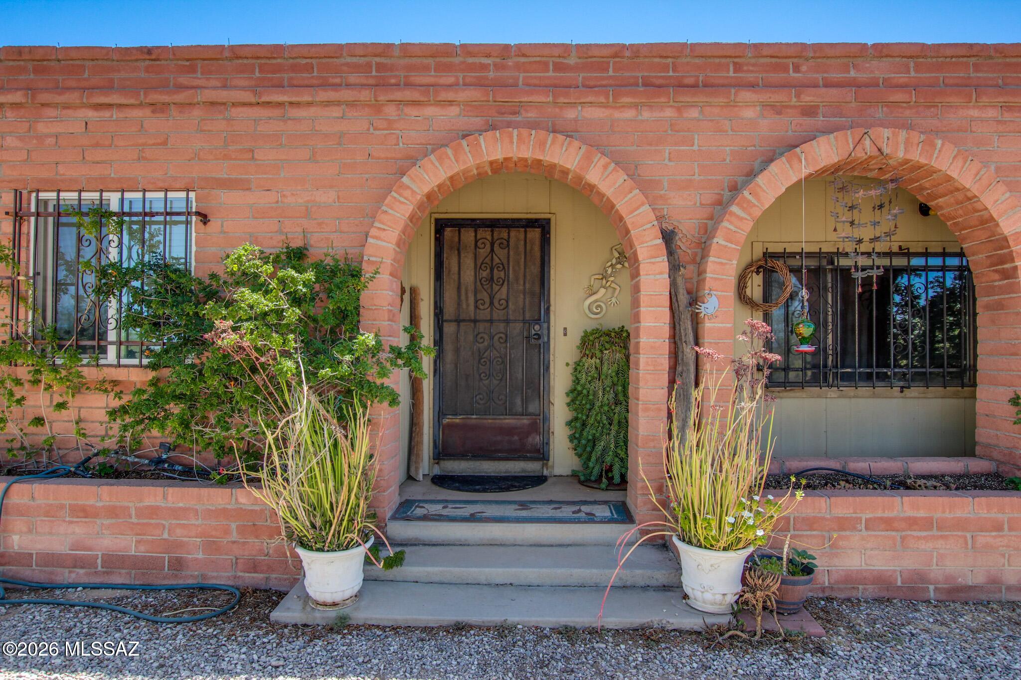 This charming ranch-style home features 3 bedrooms and 2 bathrooms with a warm, functional layout. The primary suite includes a fully updated bedroom and bathroom, creating a private retreat with modern finishes. Enjoy Arizona living in the backyard oasis complete with a sparkling pool and stunning mountain views. Horse amenities include stalls and a dedicated tack room with plenty of space for equipment and hobbies. A spacious Arizona room adds versatile living space perfect for entertaining, relaxing, a game room, or year-round enjoyment. Blending ranch charm, comfort, and country living.