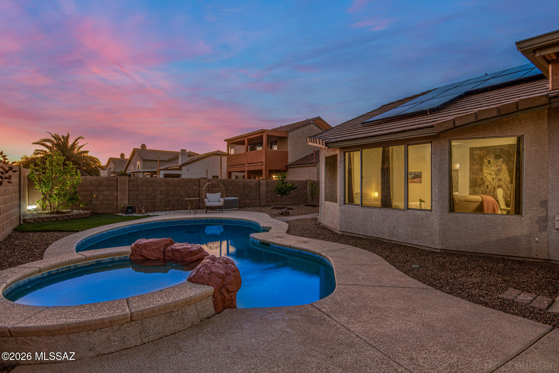 Welcome to this perfectly located 4-bedroom home with sparkling pool & spa, an ideal lot with no neighbor on one side of the home, walking path & a wash behind the house for added privacy! Did we mention the mountain views?! Inside, you'll find thoughtfully designed living spaces featuring tile floors, soaring vaulted ceilings, arched passageways, skylights, and new paint throughout. The kitchen awaits your culinary adventures and gatherings with stainless steel appliances, an open layout and a bay window. The oversized master bedroom is a true retreat, including a spacious walk-in closet and a full bathroom with double vanities. This home also features owned solar panels (installed in 2022) plus a water softener for added comfort and efficiency! A brand-new roof installed in 2026 adds even more value and peace of mind. Out back, you'll have your own private oasis, complete with a covered patio to enjoy your morning coffee, well-laid pavers, artificial grass, a relaxing spa, and a sparkling blue pool. The backyard also features a well-equipped landscape irrigation system with an in-home timer and fruit trees, including a lemon tree currently producing lemons. Truly a must-see!