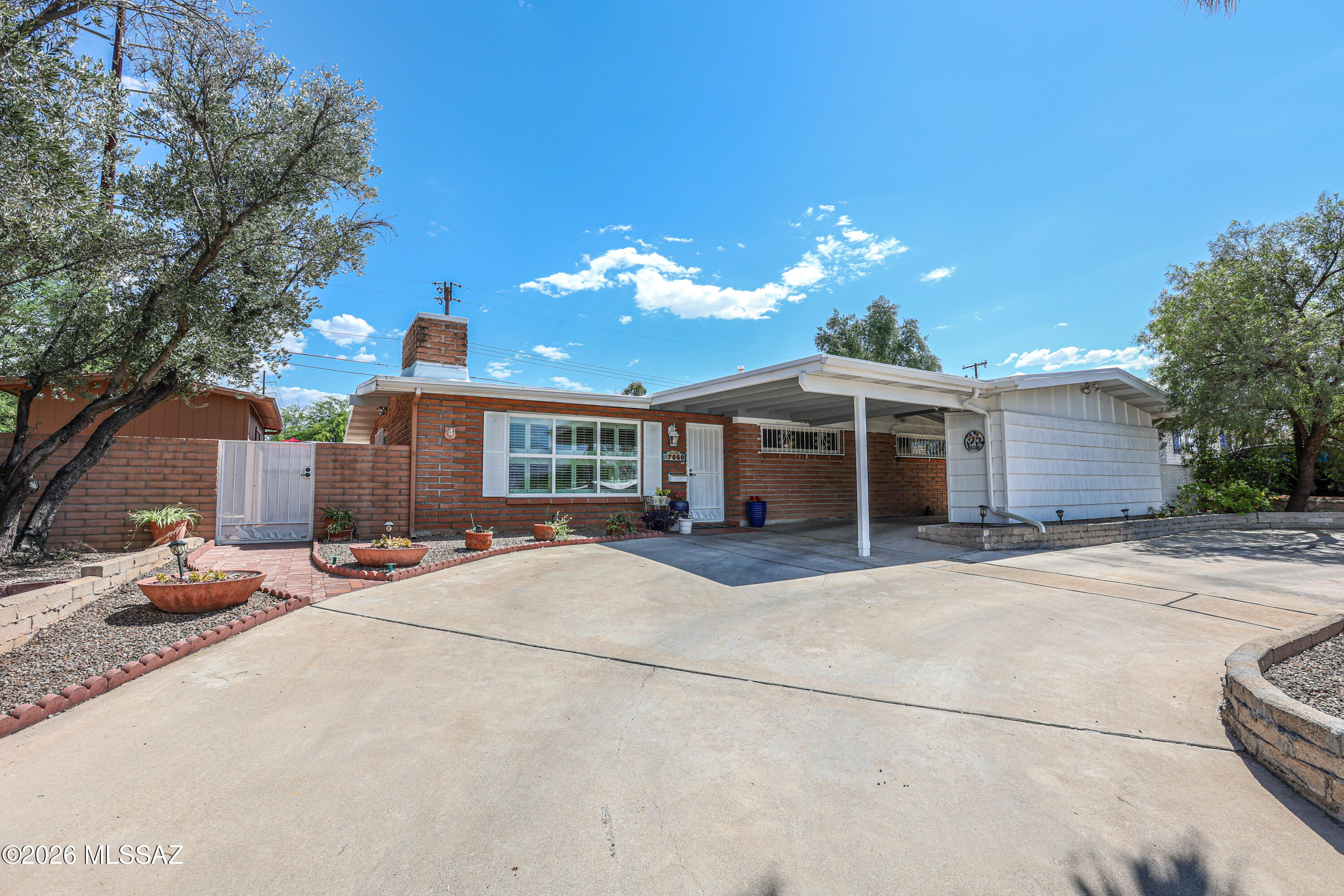 Welcome to this conveniently located mid-century home!  Pride of ownership shows throughout this 3 bed/2 bath home with no HOA.  The light and bright living room has a cozy fireplace and showcases mountain views through it windows.  The open kitchen has quartz countertops, wall oven, and a bar counter. The hall bath has a charming original vintage yellow tub! But perhaps the best part of this home is the private backyard made for entertaining. Enjoy hosting family and friends in the pool/spa and outdoor cantina. There is also a 10' x 16' workshop for your hobbies and crafts.  The carport has 2 additional storage closets.  Roof has a 5 year warranty.  Make this home yours today!