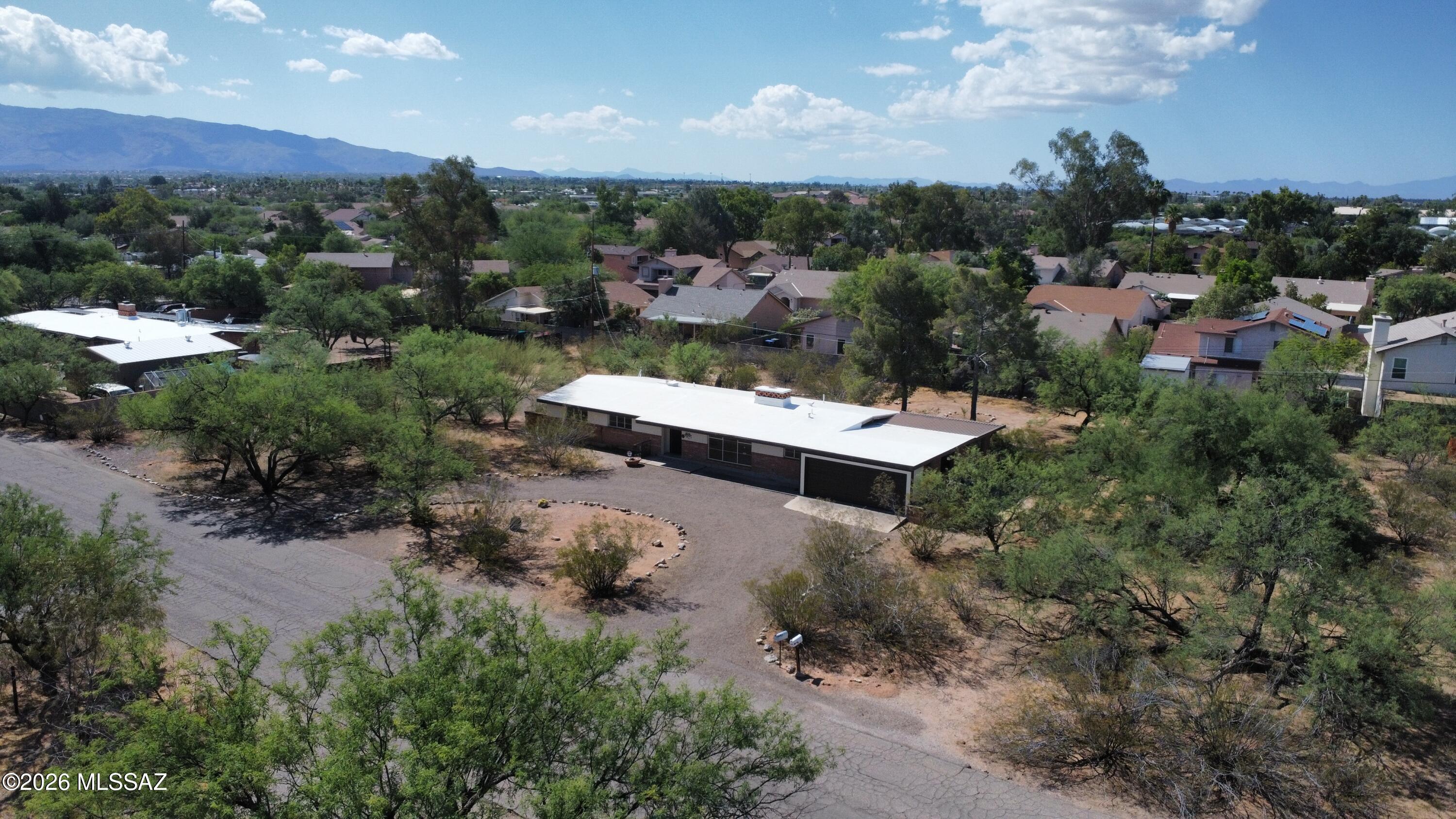 1 of only 18 OVERSIZED lots (.85 acre) in this darling, tucked-away east side subdivision. These ranch homes offer a tremendous opportunity to add on, plus still maintain privacy and space from your neighbors. Fresh paint inside and out, plus updated epoxy floor! It maintains much of the original mid-century ranch style charm, but it is also a great blank canvas that is compatible with pretty much any furniture style you choose. Bonus rooms include screened Arizona Room, plus a workshop off the garage. This home is being priced at appraised value for a quick and fair transaction!