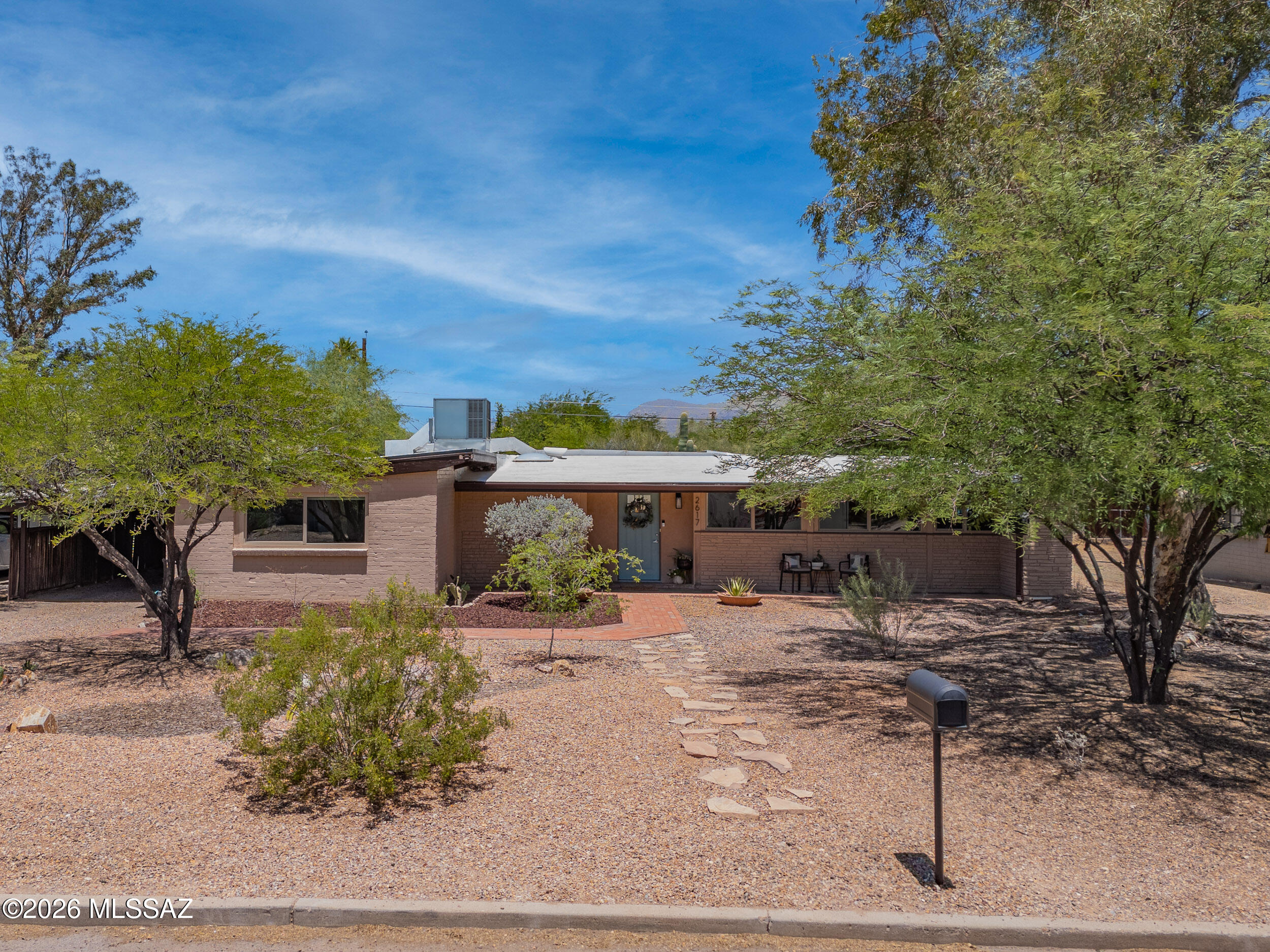 Charming Mid Century Modern home with pool! Iconic clean lines w/an emphasis on indoor-outdoor living. Stylistic windows are dual pane, lots of natural light & neutral palette throughout. Gorgeous tile flooring, beam ceiling & fp in welcoming family room. Versatile open plan offers dining spaces, work spaces & plenty of comfortable seating. Quartz kitchen counters, Shaker style cabinets, soft close drawers, smooth cooktop, dbl sink & huge walk in pantry w/barn door. Remodeled throughout. Contemporary baths w/fresh stone & tiles vanities & tub/shower surrounds. Central location is convenient to new local dining such as Snooze & Postino's. Favorably located to Downtown, U of A & Himmel Park offering pickleball! Beautiful pool, more yard for gardening & detached 9x12 shed w/elec & window AC.