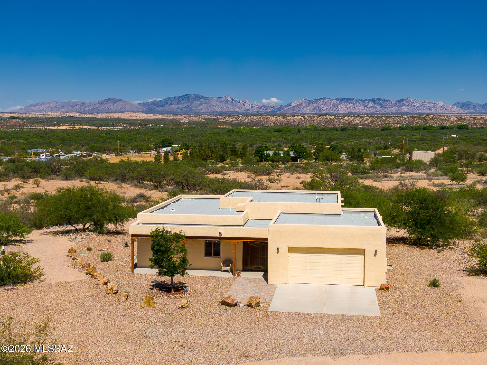 Beautiful custom Santa Fe style home on 40 private acres featuring energy-efficient insulated concrete form (ICF) construction for superior durability, quiet interiors, year-round comfort, and low utility costs. This 3-bd, 2-ba home offers panoramic views of the San Pedro Valley and 8 mountain ranges. Enjoy Southwest charm with thick walls, high ceilings, and peaceful living spaces. Property includes a 30' x 40' workshop/garage with 12' ceilings, a separate 12' x 24' studio, full-hookup RV site with 20/30/50 amp service, propane, septic, and onsite EV charger. A rare Arizona retreat combining beauty, efficiency, and versatility. No HOA. No CC&Rs.