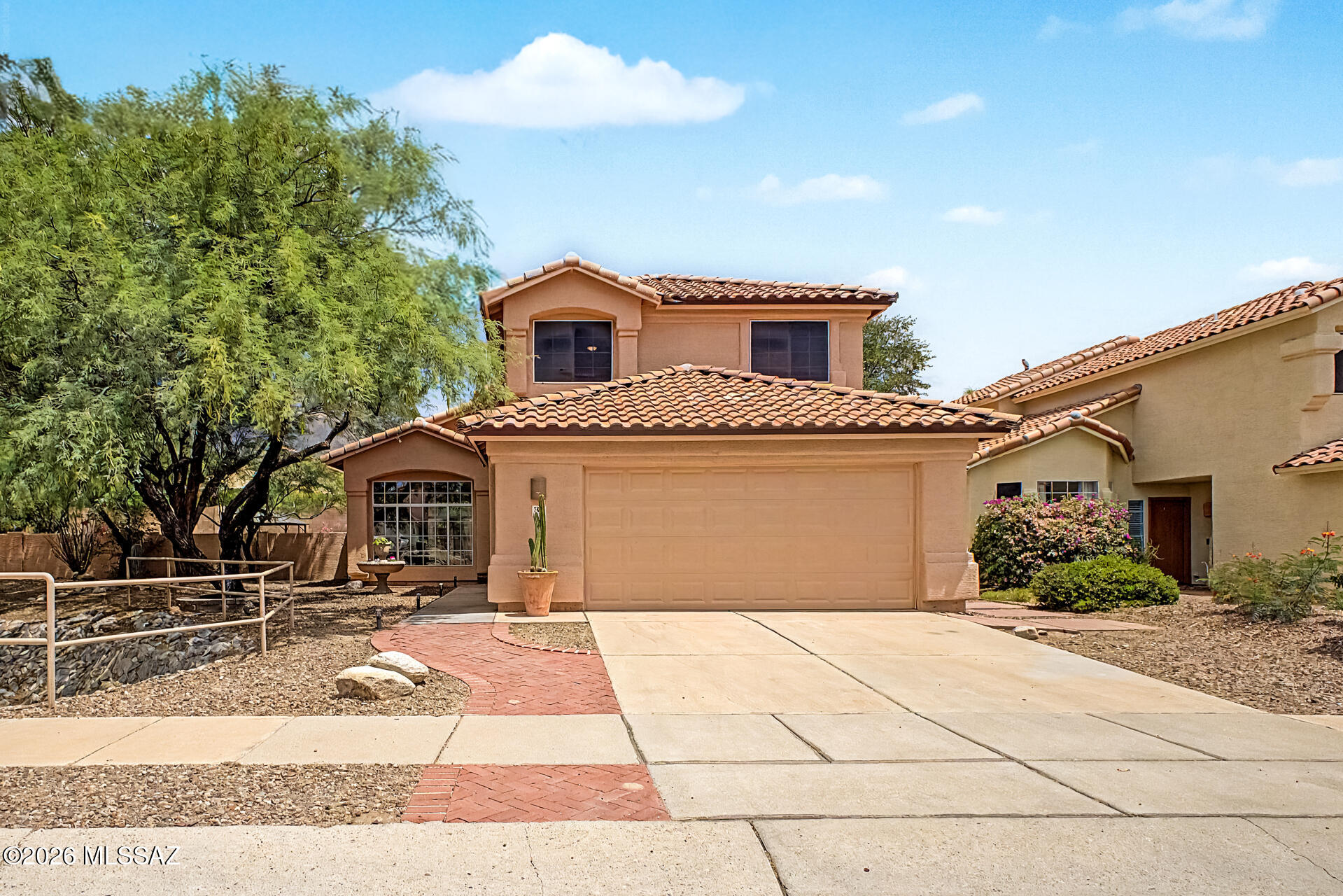 This exceptional 4-bedroom, 3-bathroom home is ideally situated in one of the area's most desirable locations. Featuring one of the few oversized lots in the neighborhood, complete with a sparkling swimming pool, this property offers the perfect blend of comfort, space, and outdoor living.

Step inside to discover an abundance of natural light, soaring vaulted ceilings, and a grand staircase that creates an impressive first impression. The main level features durable laminate and ceramic flooring, while brand-new carpeting adds warmth and comfort throughout the upstairs living spaces. Oversized picture windows enhance the spacious living and dining areas, creating an inviting atmosphere for both everyday living and entertaining. The beautifully updated kitchen is equipped with stainless steel appliances, quartz countertops, a convenient breakfast bar and a built in desk/office space. A charming breakfast nook flows seamlessly into the cozy family room, making this the true heart of the home.

Upstairs, you'll find an expansive primary suite offering a private walkout balcony with peaceful surroundings and partial mountain views. The luxurious primary bathroom features double sink vanity, a relaxing garden tub, a walk-in shower, a private water closet, and an oversized walk-in closet. Two additional generously sized guest bedrooms and a full guest bathroom with a tub/shower combination complete the upper level.

This move-in-ready home boasts a newer roof, newer HVAC system, and numerous thoughtful upgrades throughout.

Step outside to your own backyard retreat, featuring a covered patio, fire pit, raised garden beds, lush natural grass, and mature mesquite trees that provide ample shade. Whether you're relaxing poolside on warm summer days or entertaining guests under the canopy of trees, this outdoor space is designed to be enjoyed year-round.

Conveniently located near shopping, exquisite restaurants, the renowned Sabino Canyon Recreation Area and within the highly sought-after Catalina Foothills School District, this home also offers direct walking access to top-rated schools through a private neighborhood pathway.

This is a rare opportunity to own a beautifully updated home on an oversized lot in an unbeatable location.