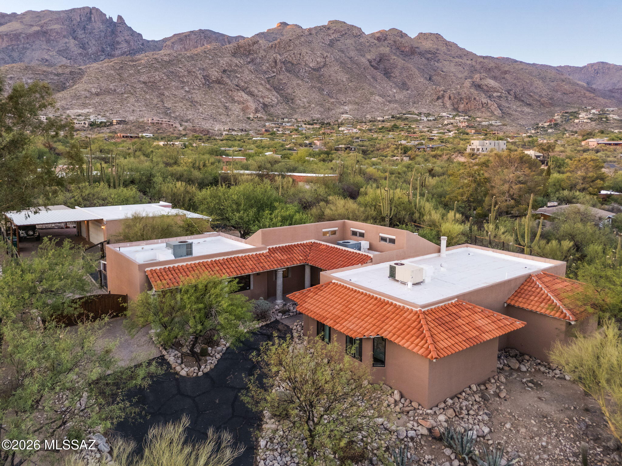 Welcome to this truly exceptional residence nestled on a generous 0.80-acre lot in the sought-after Coronado Foothills Estates (no mandatory HOA!). Thoughtfully designed living space, this home features 4 spacious bedrooms, a private library, dedicated office, 2 full baths, & 2 additional half baths-ideal for both relaxed living and entertaining. Inside, you'll find an open floor plan enhanced by gorgeous, exposed beams, multiple living areas, and a true chef's kitchen complete with double ovens, cooktop, two sinks, wet bar, & a brand-new smart refrigerator. Primary suite is a private retreat with a cozy fireplace, private balcony, dual vanities (including a makeup station), a soaking tub with jaw-dropping mountain views, & a separate walk-in shower. Step outside to enjoy multiple (cont) patios & balconies, a sparkling pool, & views of the Catalina Mountains. This property also boasts ample guest parking, a 4-car carport, & a mechanic's dream 3-car garage with 240V power & HVAC-ready setup-secured behind an electric gate. Garage and Pool Bath can easily be converted to a separate Casita. All located within the prestigious Catalina Foothills School District-this is a rare opportunity to own a well-maintained & updated home with space, character, & stunning views. All located within the prestigious Catalina Foothills School District, minutes from La Encantada, Sabino Canyon and world class golf and resortsDon't miss your chance to tour this unique Tucson gem!