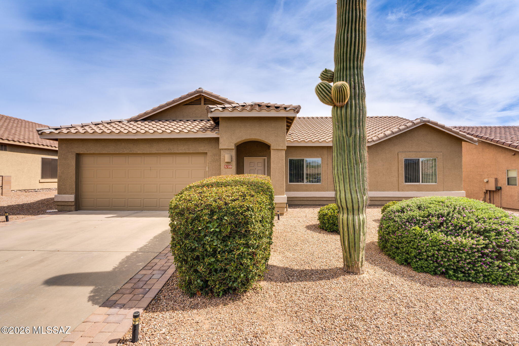 Bright and cheery 3BD/2BA (1,738 sq ft) home on elevated lot at Dove Mountain's Quail Crossing offers a spacious yard with Catalina views to one side. New roof, interior and exterior paint, and a fantastic newly screened patio. This elegant home showcases a formal living room off foyer plus cozy Great room for casual living/dining. Chef's kitchen hosts new granite countertops, breakfast bar island, dining nook with bay window and large walk-in pantry. Elegant Owner's suite with bay window offers a dual sink vanity plus walk-in shower and custom closet. Two guest rooms access hall bath. Retreat outdoors to a spectacular yard boasting extended covered patio, brick paver walkway and outer patio, privacy wall and hedges, plus lush landscaping. Dove Mountain is home to the Ritz-Carlton Resort, sport parks, golf, hiking/biking trails and more!