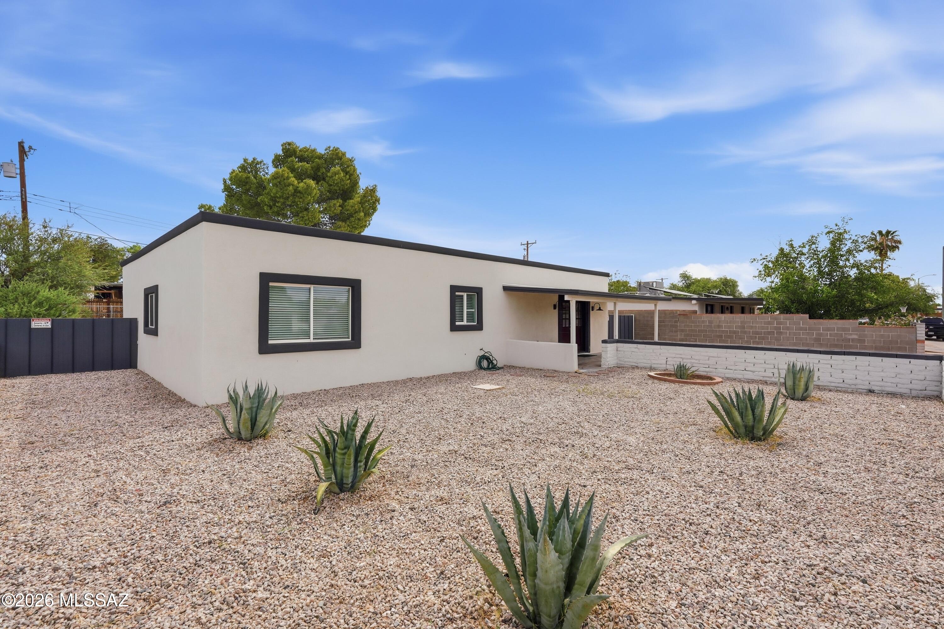 Welcome home to this stunning 4-bedroom, 2-bathroom residence that has been thoughtfully remodeled from top to bottom. Nearly every major component has been updated, giving you the peace of mind of a modern home while maintaining timeless charm. Step inside to an open-concept floor plan filled with natural light, featuring elegant oversized tile flooring, recessed lighting, fresh paint, and striking architectural beams that create a warm, contemporary feel. The beautifully redesigned kitchen is the heart of the home, showcasing white shaker cabinetry, sleek quartz countertops, stainless steel appliances, a spacious island with additional storage, and stylish modern lighting. Beyond the beautiful finishes, this home offers extensive upgrades. Schedule a showing today!