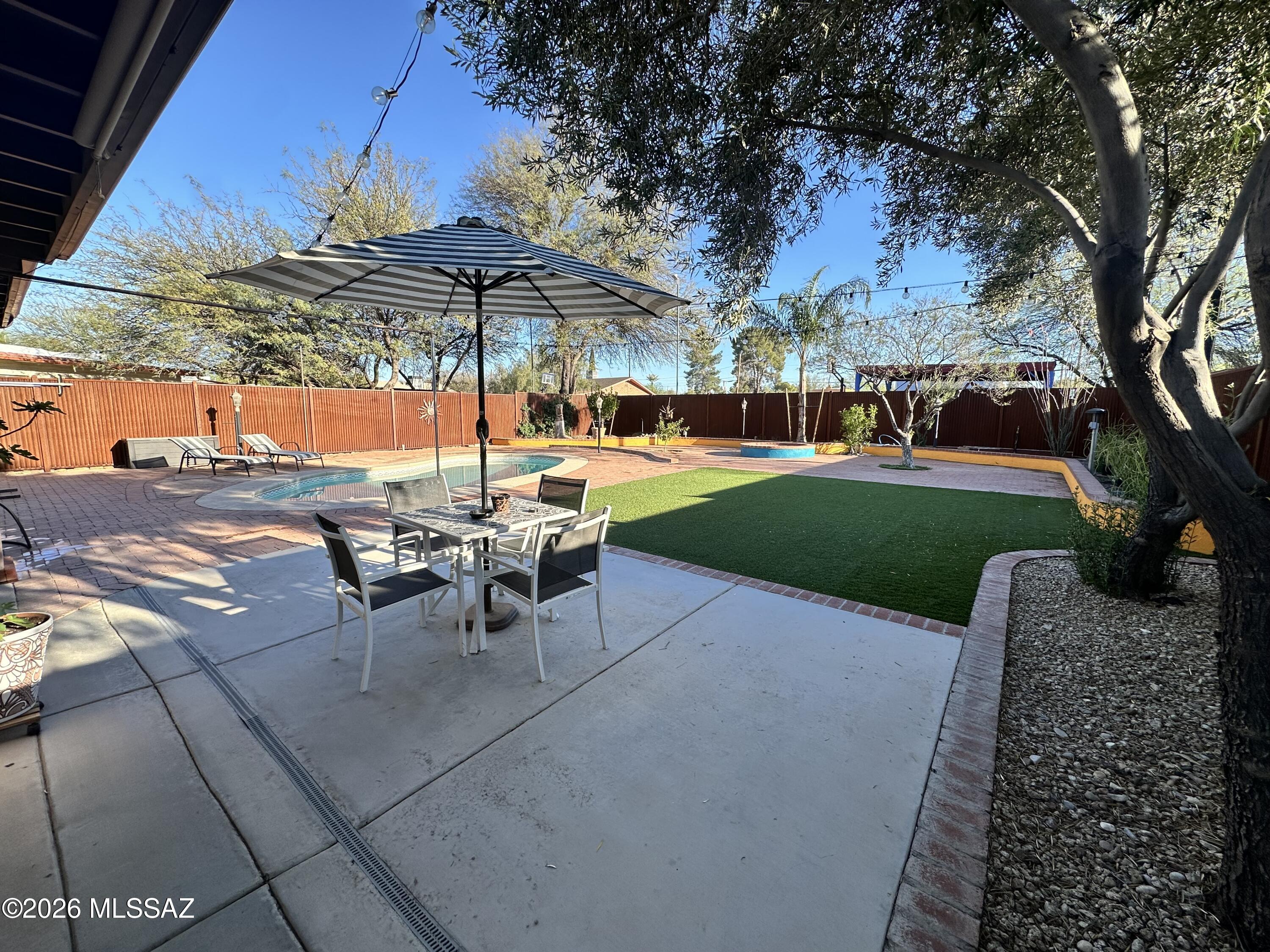 Privacy abounds with desirable metal fencing surrounding this cute Santa Fe Style Retreat and a fantastic pool and backyard with a BBQ included in this wonderful oasis. This central location is very convenient to TMC Hospital, St. Joseph's Hospital, Davis-Monthan, U of A, restaurants, shopping and The Loop Trail for walking/running/biking.  Featuring an open floorplan with 3 BDRM/2 BA, kitchen with granite and stainless appliances, large primary suite, all tile floors, 2 car garage (epoxy-coated) and new HVAC system affords a comfortable way of living.  **Pets considered on approval by owner.**  MUST MAKE APPOINTMENT.  (Owner related to LA).