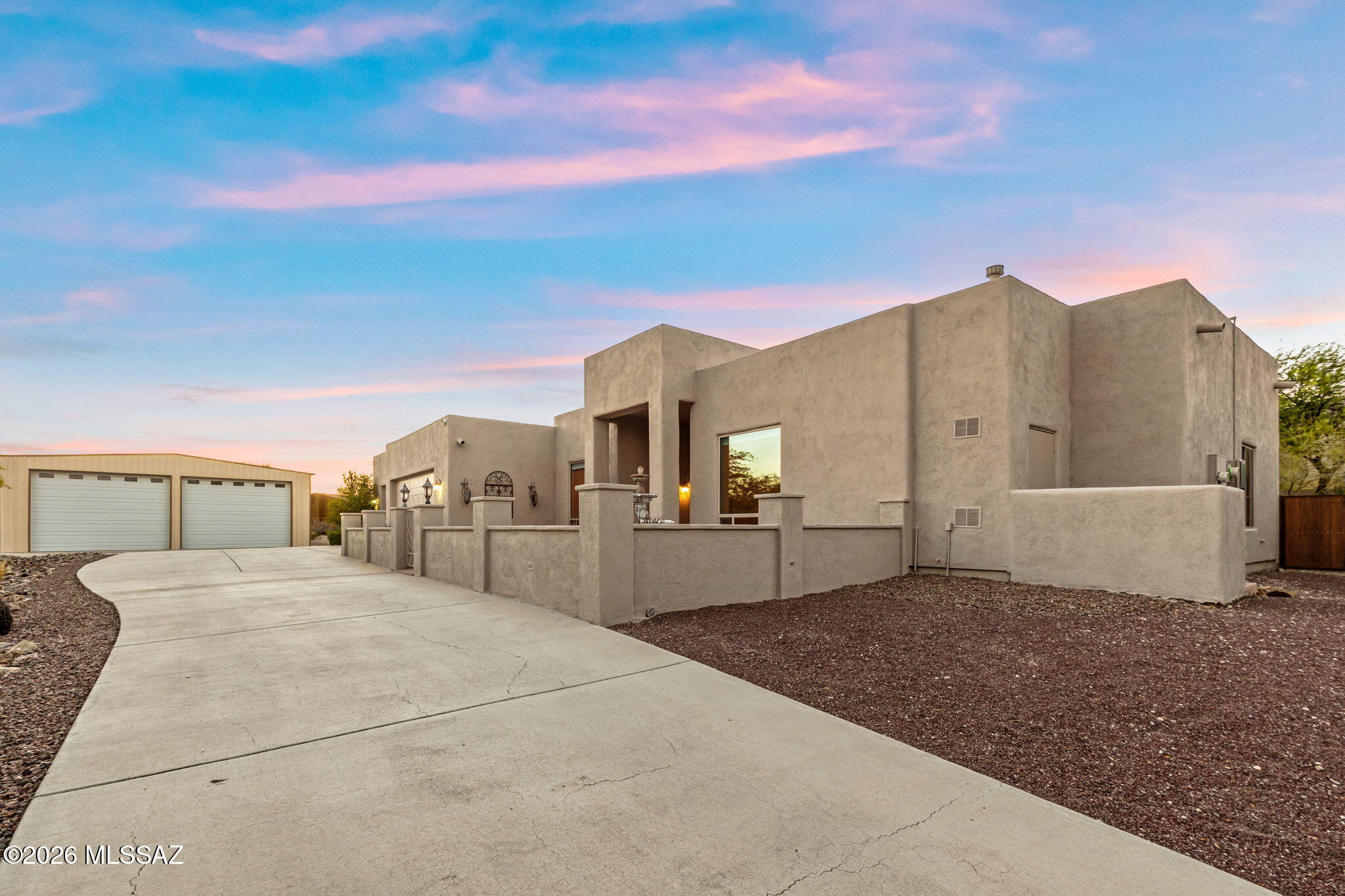 Set on over an acre with breathtaking Catalina Mountain views, this custom contemporary residence blends timeless design with exceptional craftsmanship. Expansive windows frame the surrounding landscape, while rich knotty alder millwork adds warmth throughout the 3,113 sqft open concept floor plan. The chef's kitchen features an oversized granite island, double ovens, gas cooktop, beverage refrigerator, and breakfast nook overlooking the fireside family room. Each of the four bedrooms offers a private en-suite bath, including a serene owner's retreat with patio access. A landscaped courtyard, owned solar, a permitted 2,700 sq ft RV garage/workshop, abundant parking, and no HOA complete this remarkable property.