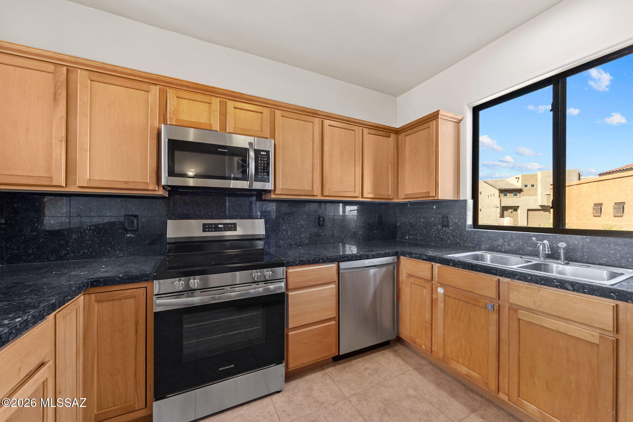 Move-In Ready | First Floor Primary Suite | All Upgrades Completed June 2026 for Buyer's Exclusive Use | New Stainless Kitchen Appliance Suite | New Neutral-Tone Carpet | Full Interior Freshly Painted including 2 Car Garage | Re-Roof and Resurface Coating | 3 Bed | 3 Bath | 1735 sqft |  Light and bright with soaring ceilings, this end-unit townhome with east-facing showcases views of the Santa Rita Mountains. Kitchen boast brand new appliances with manufacture warranties, granite counters, pantry, built-in wine rack, and a well-designed work space that is open to the spacious dining and living areas. Primary suite offers walk-in closet, dual sinks, large shower. Large guest suites on second floor have ample closet space and a Jack-Jill bathroom. Peaceful and easy care living awaits you!