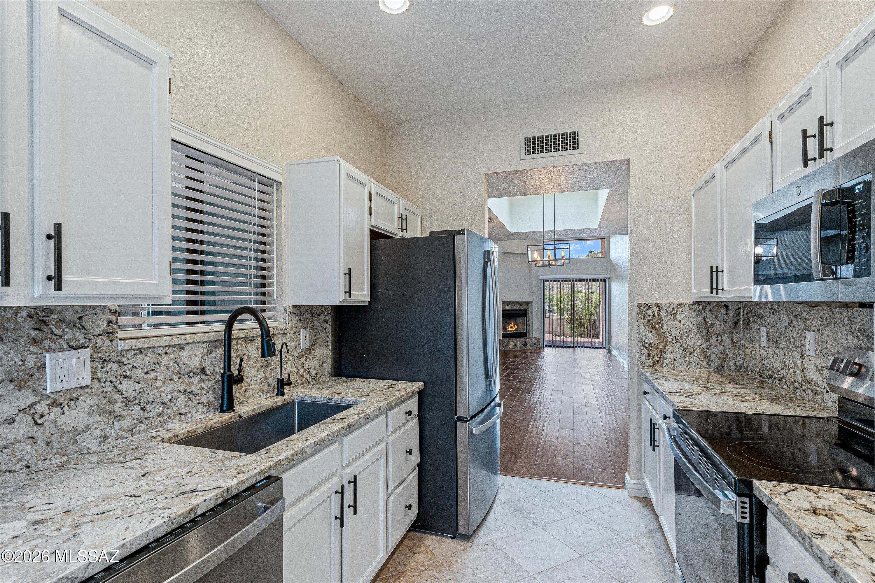 Charming single story Catalina Foothills townhouse with city and mountain views. This private home features a gated courtyard entryway, North / South orientation, backyard with a covered patio and Rincon Mountain & city views, high ceilings throughout, wood flooring, new paint throughout, updated kitchen & bathrooms, new light fixtures, new appliances, gas fireplace,  eat-in kitchen. Amenities include pool & hot tub, recreation center with kitchen facilities and a convenient location near shopping, restaurants and Sabino Canyon Park. The Valle Townhouses are a small community of only 49 properties and homes rarely come on the market.