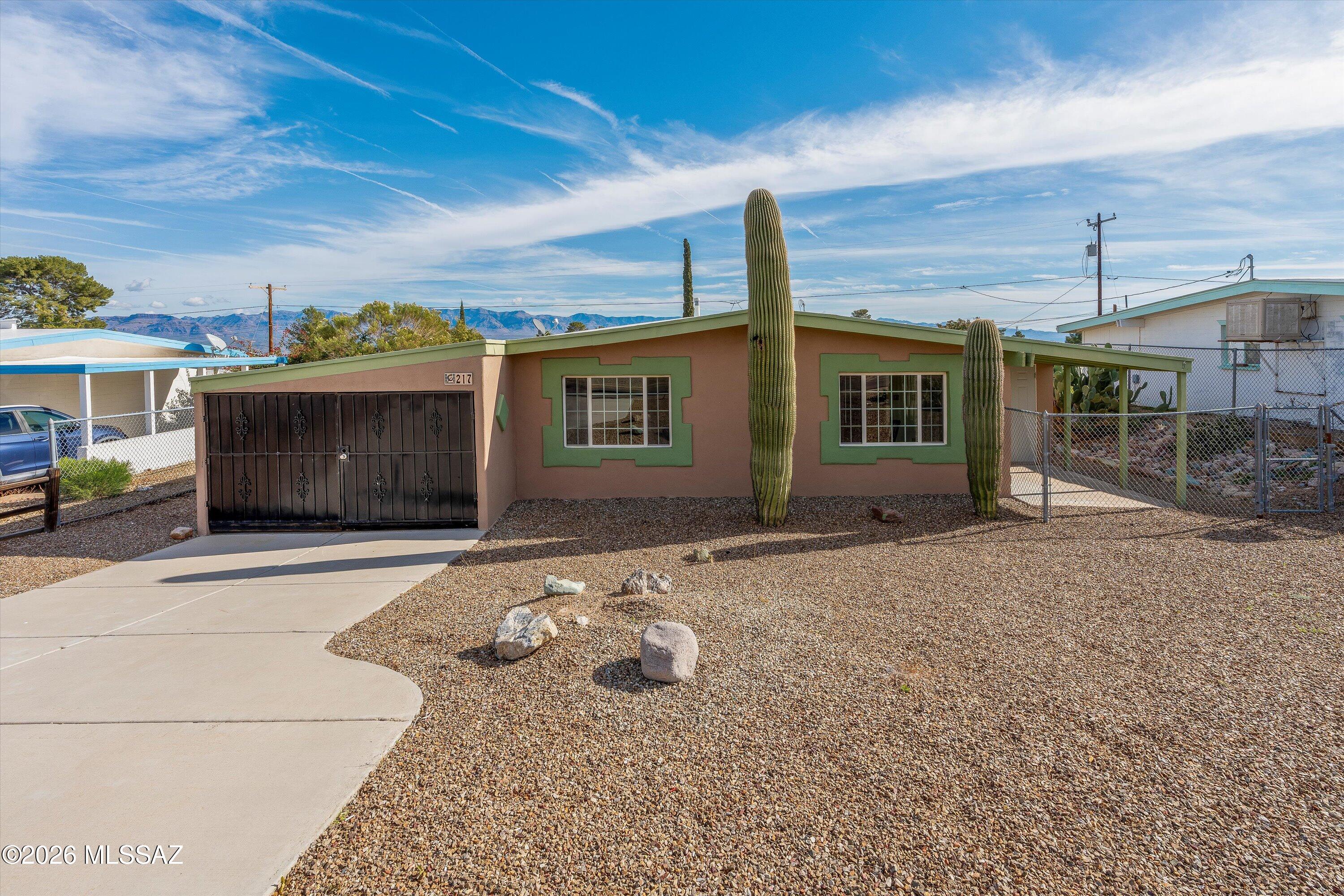 This thoughtfully updated 3-bedroom, 1-bath home offers a fresh, inviting interior designed for everyday comfort. New carpet enhances the living and bedroom spaces, while large dual-pane windows fill the home with abundant natural light and frame scenic views of the Galiuro Mountains. The kitchen is equipped with a gas stove, stainless steel refrigerator, and dishwasher, combining function with a modern look. Step outside to a generously sized backyard enclosed by a chain-link fence, providing flexible outdoor space for a variety of uses. A washer and dryer are conveniently located in an exterior laundry closet, adding practicality without taking up interior square footage.