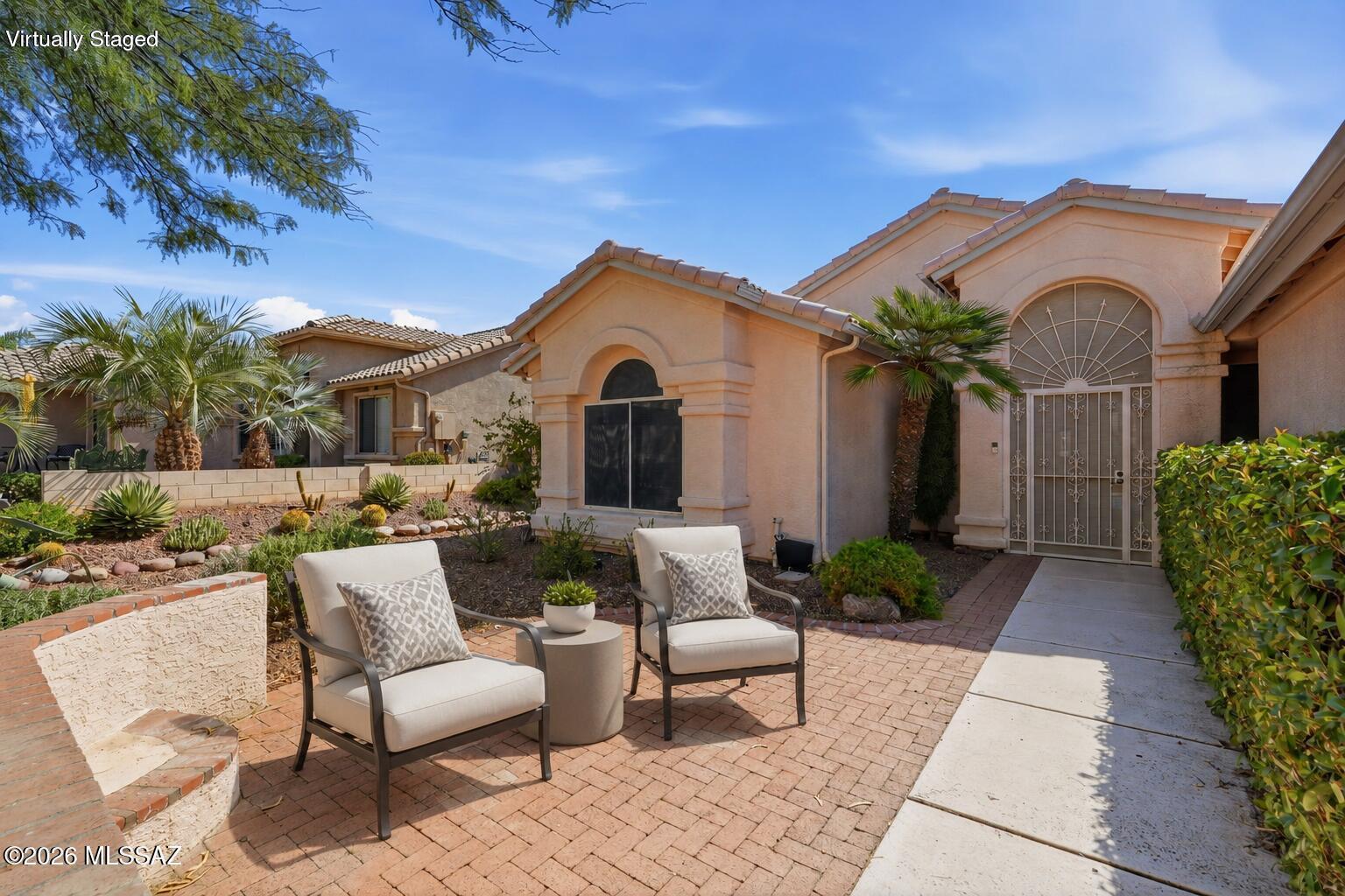 This lovely Paloma floorplan is located in the highly sought-after SaddleBrooke community. This beautifully maintained 2-bedroom + den, 2.5-bath home offers an open floor plan with high ceilings and neutral ceramic tile throughout. The bright kitchen features abundant cabinetry and generous counter space, flowing seamlessly into the spacious living and dining areas. The large primary suite includes dual vanities, a walk-in shower, and a relaxing soaking tub. Step outside to a covered patio with ceiling fans, and AMAZING MOUNTAIN VIEWS, surrounded by mature desert landscaping. A front courtyard and security gate adds convenience. Enjoy SaddleBrooke's exceptional amenities, including golf, fitness centers, pools, dining, and an active resort-style lifestyle.