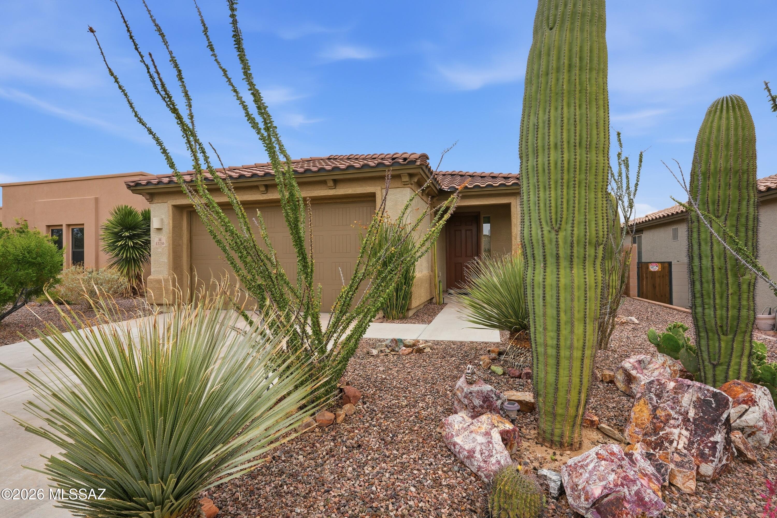 Welcome to your pristine desert oasis in an exclusive gated community at Dove Mountain! Built in 2015, this meticulously crafted 3BD/2BA (1,900 sqft) residence perfectly embodies the relaxed sophistication of the luxury Northwest corridor, offering a turn-key escape surrounded by high-desert beauty. From the moment you step inside, the home greets you with a bright, open-concept floor plan designed for effortless modern living. Large windows frame the serene surroundings while drawing in an abundance of natural Arizona sunlight. The heart of the home is a thoughtfully configured kitchen that flows seamlessly into the main great room area, creating an inviting hub for casual weekend hosting or quiet, peaceful evenings. The functional layout provides everyone with an added level of privacy and daily convenience. The living space transitions beautifully to the outdoors, where a private rear covered patio awaits. Situated on a manageable private lot, the backyard offers a low-maintenance sanctuary that allows you to spend less time on yard work and more time enjoying the world-class lifestyle of Dove Mountain. Whether you are looking for a lock-and-leave seasonal destination or a permanent desert retreat, this property delivers ultimate peace of mind in a phenomenal neighborhood setting. Residents enjoy proximity to miles of paved walking trails, neighborhood parks, multi-use paths, and the globally acclaimed golf and resort amenities that make Dove Mountain one of Southern Arizona's most coveted zip codes!