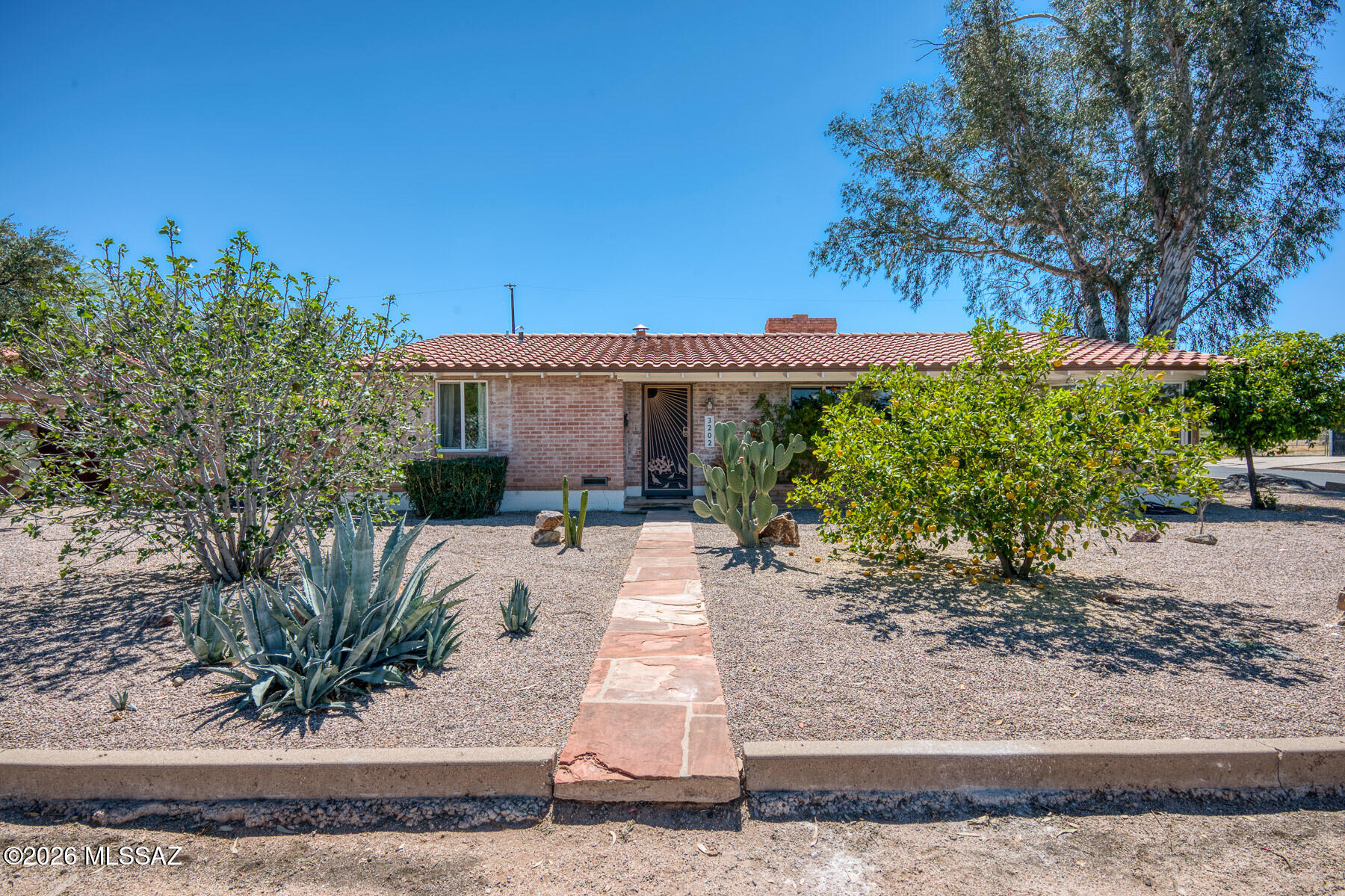 Warm and inviting brick home on a spacious corner lot, ideally located near the University of Arizona, Banner Hospital, and nearby schools. The 3 bed, 2 bath main residence features both a comfortable living room and separate family room, plus a dedicated dining area--perfect for everyday living and entertaining. A private 1 bed casita with kitchenette offers ideal space for guests or rental potential. The backyard is a true retreat with a sparkling pool and a charming ramada with a built-in wood-burning fireplace. Mature citrus trees grace the property, adding to the home's appeal. A wonderful blend of comfort, flexibility, and outdoor living!