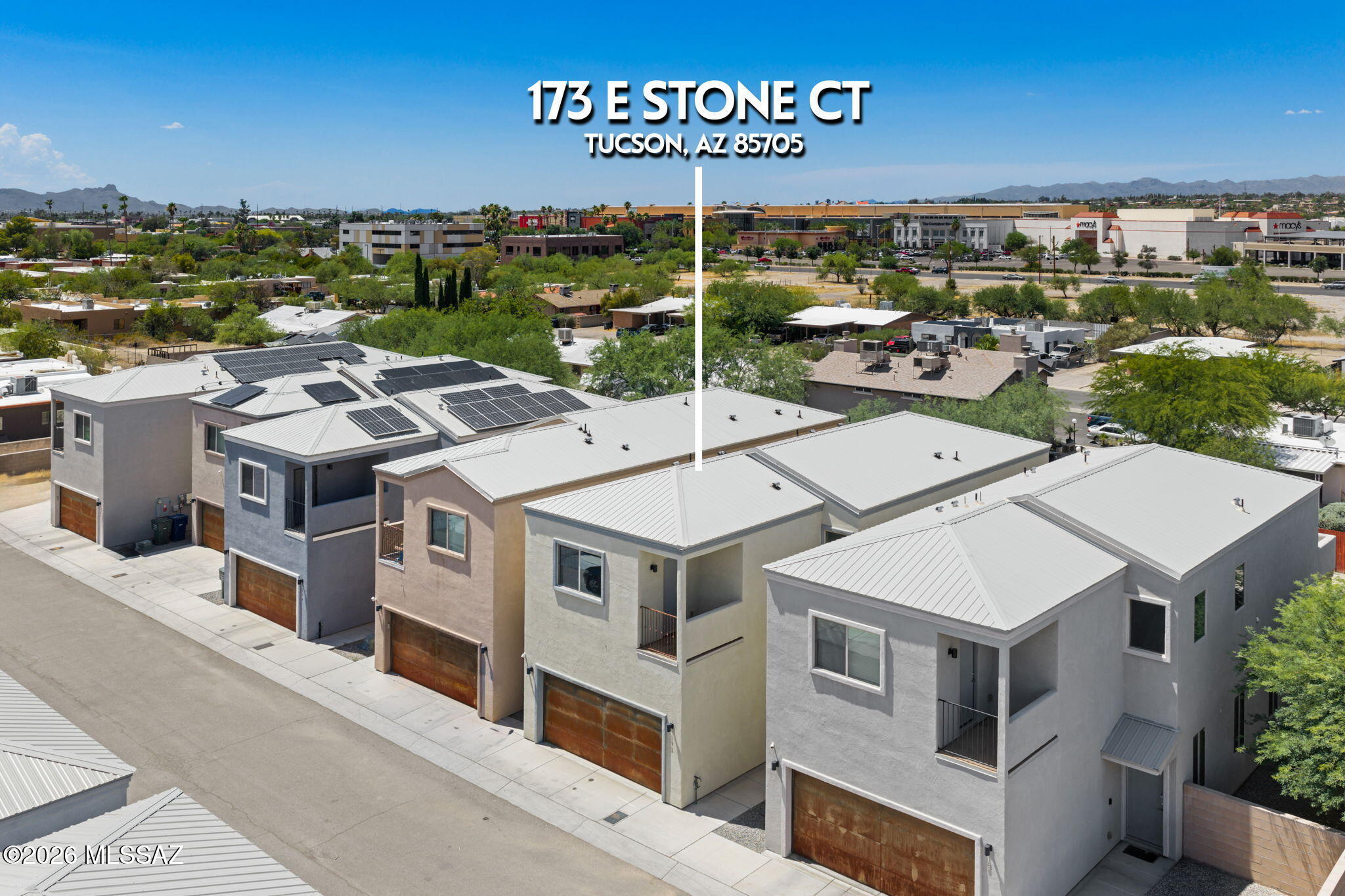Welcome home to a warm and inviting Modern Southwest small urban infill footprint designed by Sonoran Design Group for Stone Lane Homes, a quiet private enclave of just 12 homes, where beautiful Catalina Mountain views set the scene for everyday living. With no HOA, this move-in ready home offers the comfort, freedom, and flexibility today's buyers love. Featuring 4 bedrooms and 4 bathrooms (2 primary suites w/private balconies), including a convenient lower level guest bedroom and full bath, ideal for multigenerational living or office setup.  The main primary bedroom features mountain views, a large luxury ensuite spa bath with dual sinks, elongated free-standing soaking tub and separate walk-in shower with tile surrounds, and a generous walk-in closet. The open-concept great room blends seamlessly into the kitchen space, perfect for entertaining.  Modern wrought iron railing in stairway.  Inside, upgraded marble flooring in the main living areas brings a polished touch, while stainless appliances, granite counters and included refrigerator, washer, and dryer, with an acceptable offer, make settling in a breeze. Elegant French doors to the back yard.  Step outside to enjoy two private balconies, a spacious back yard, and an extended-length patio, perfect for morning coffee, sunrise and sunset views, weekend gatherings, or simply unwinding in the Arizona sunshine.  With low-maintenance living, energy-efficient features, a 2-car garage, and a prime midtown location just minutes from the UofA, medical and hospital services, dining, entertainment, shopping, and I-10, this home is ready to welcome its next owner. Come see it for yourself and imagine the lifestyle waiting for you here.  Enjoy relaxed everyday living.