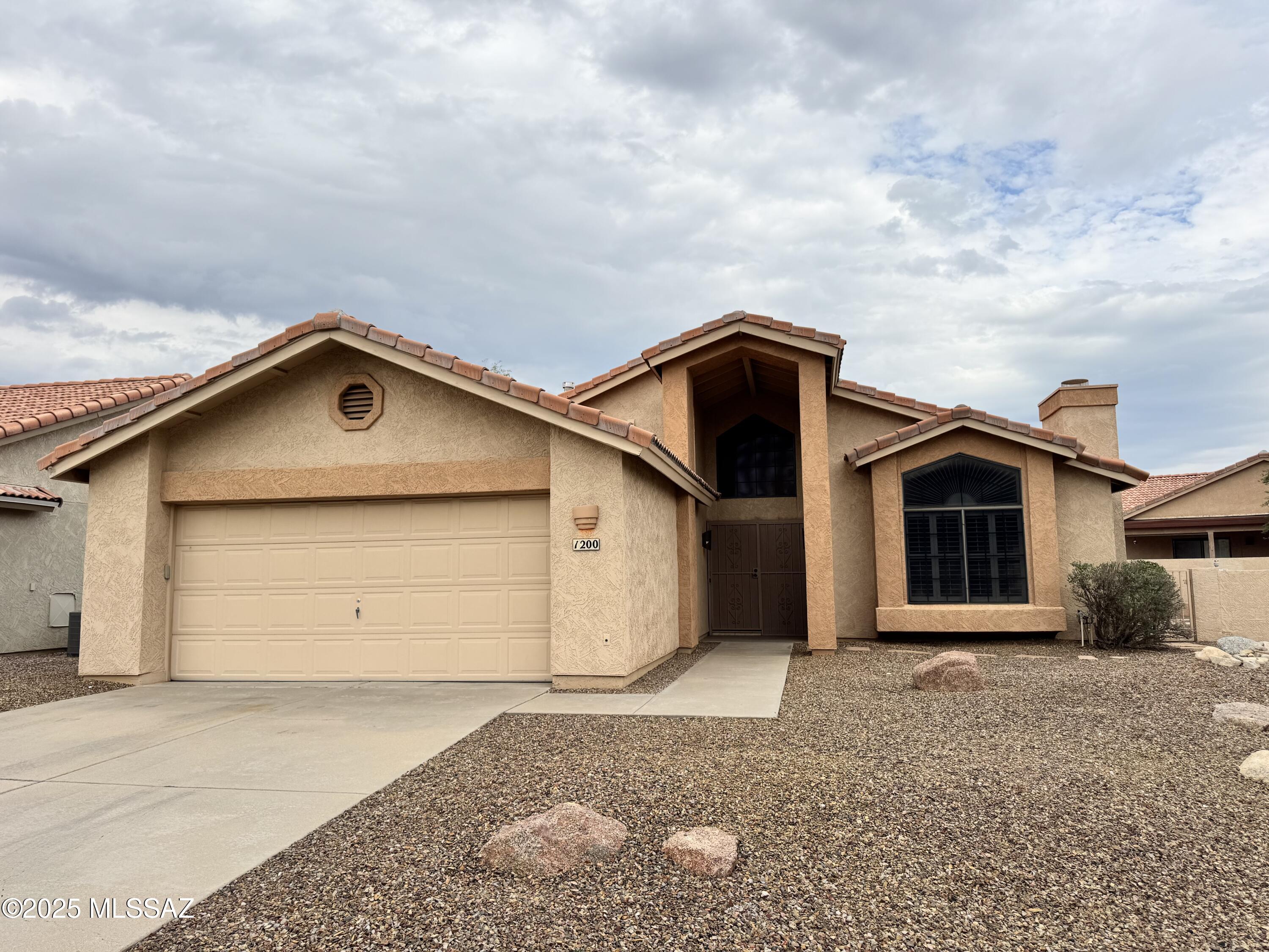 Welcome Home!! Located in a highly desirable Oro Valley community, this charming residence is a perfect blend of comfort and style, featuring a spacious 2-car garage and a meticulously and easily maintained yard for year-round enjoyment. Step inside to an inviting great room with high ceilings, large windows and fireplace for the cool nights. The great room over-looks the designer styled kitchen area. With this remodeled kitchen, culinary enthusiast will love this kitchen with granite countertops, all appliances, and high-end knotty alder wood cabinets.  Plus, a large pantry, a two-tier island with cooktop, enough room for all of your entertaining. The backyard sets the stage for cozy evenings spent with family and friends as you enjoy the water feature and large beehive fireplace and seating area. The backyard is a peaceful, tranquil oasis featuring a charming fountain, and ample space to add an outdoor kitchen or BBQ grill. Wait until you see the mountain views!