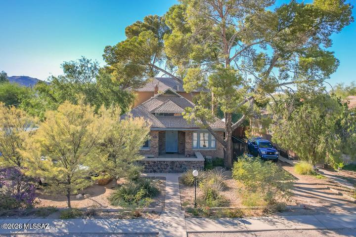 Located in the historic West University neighborhood just one block to the UofA campus, and blocks to University Boulevard Main Gate Center with shopping, entertainment,  restaurants, and the modern street car to take you to 4th Avenue and down town.  This home is loaded with character and charm built in 1921 with 5 Bedrooms, 2 baths, a living room with stone fireplace, formal dining room, office area, high ceilings, spacious kitchen, large bedrooms, walk-in closets, and views. 800 sq foot basement perfect for extra storage and workshop.