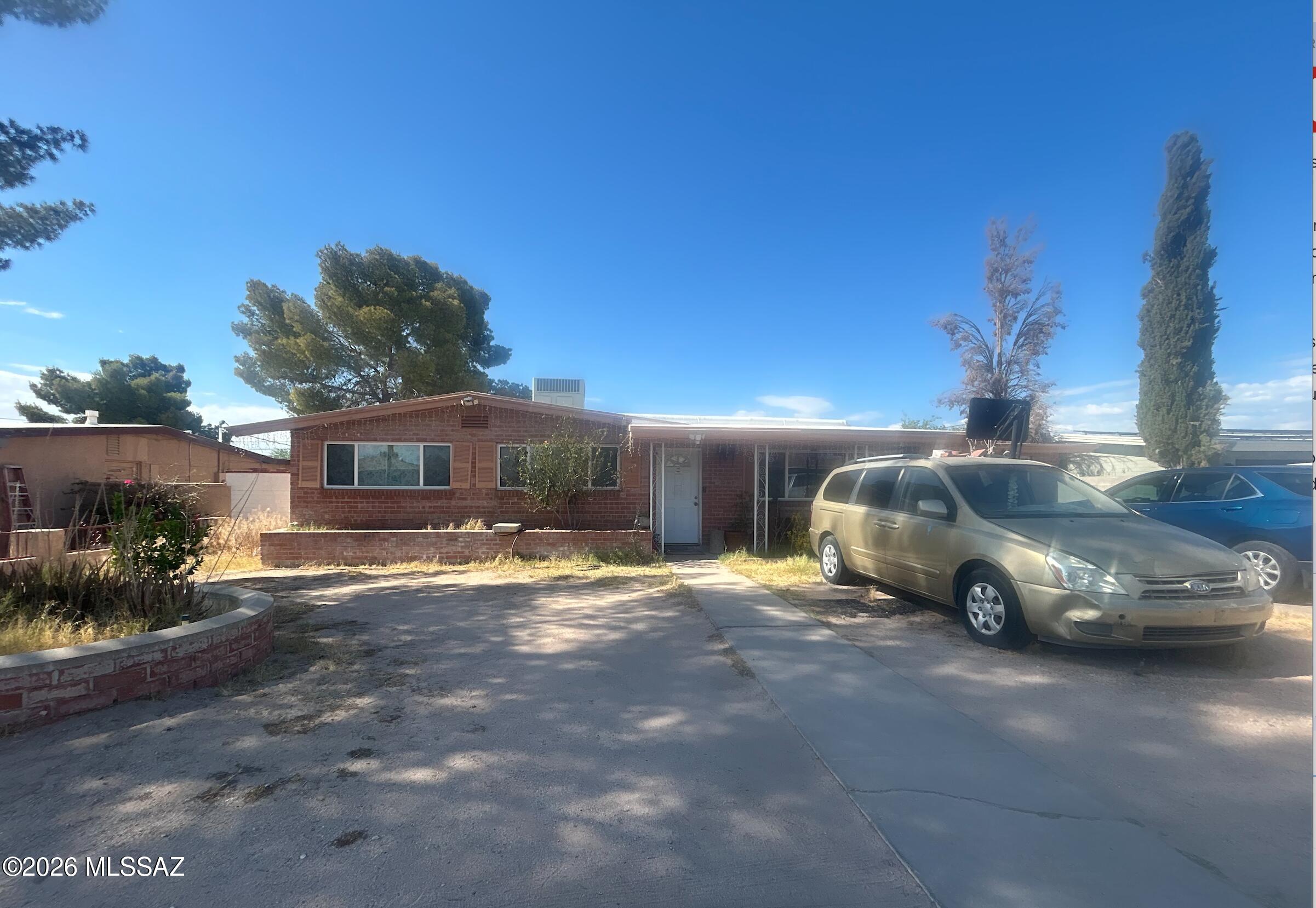 Spacious 2,186 sq ft single-level brick home in Mission Manor with 3 bedrooms, 2 bathrooms, flexible bonus/office spaces, and a large 8,109 sq ft lot. Strong layout with multiple living areas, tile/carpet/concrete flooring, ceiling fans, inside laundry area, and no HOA. Major upside for an owner occupant, landlord, or investor looking for a value-add opportunity in Tucson. Property features refrigeration, updated heat pump/HVAC per seller, public sewer, city water, and a built-up roof that was recently recoated per seller. Home is occupied and being sold as-is. Excellent opportunity to renovate, customize, or add to a rental portfolio in an established South Tucson location near Valencia Rd, I-19, shopping, and services.