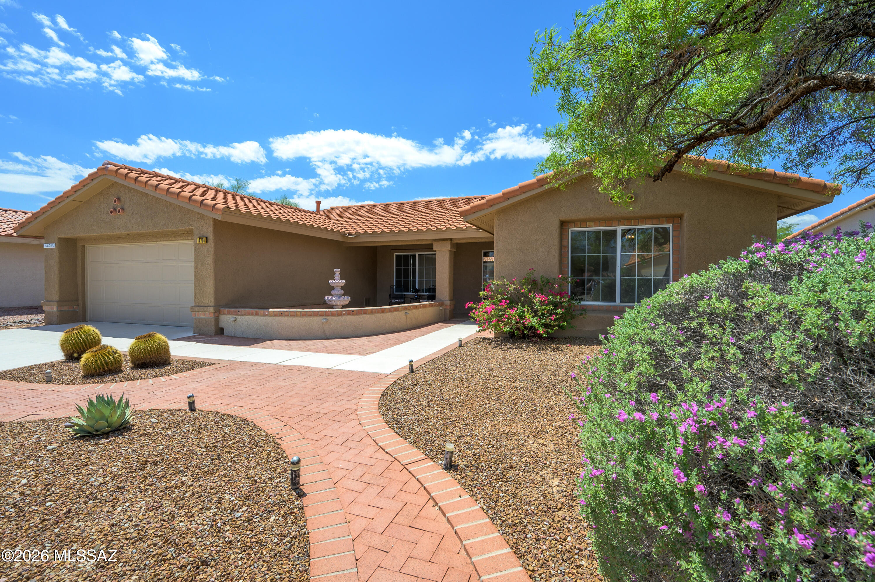If you're looking for a well-kept, move-in ready, ''just waiting for your finishing touches'' home in coveted Sun City Oro Valley, your wait may be over! Boasting 1,418 sf & sitting on a large lot, this easy-living Sabino model home is a rare find. Freshly painted interior & exterior, tile & laminate flooring, light & bright spaces & a pretty Chef's kitchen overlooking the lush backyard are added bonuses. You'll love the crisp white kitchen cabinets, stainless gas range & refrigerator, pull-outs, full pantry closet & sunny kitchen nook complete with a sliding door for easy access to the extended tiled & brick back patio. You'll feel welcomed into this home by the front courtyard with its tiled & covered porch - perfect for relaxing & enjoying some mountain views. When you enter the spacious living & dining area, you'll enjoy the expansive views of the peaceful backyard. The Primary bedroom invites you to take in more views of the lovely backyard through it's large bay window. The en-suite bath is complete with a dual vanity, updated lighting, a walk-in shower & a roomy walk-in closet. The generously sized guest bedroom, located at the front of the home, has close proximity to the hallway bath & provides more views of the mountains. The bonus room has a built-in desk and storage cabinets. The garage has a tiled laundry area featuring a utility sink, ample storage space & a work-bench area. Roof & HVAC are 5 years old. Don't miss this special, move-in ready home. You can begin your active adult lifestyle today!