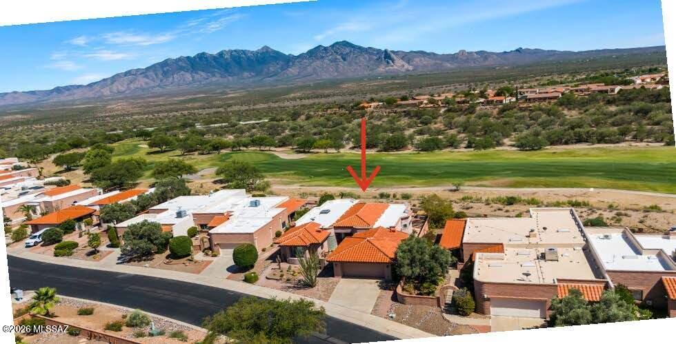 Discover spectacular unobstructed Santa Rita mountain views in this exceptional home located on the 4th fairway of the San Ignacio golf course.  Capture the essence of desert living with a design offering the perfect blend of formal elegance and comfortable everyday living. Flexible spaces can easily be adapted for a home office, media room, or hobby area. A custom gas fireplace creates a warm focal point, while built-in shelving in Bedroom 3 and a Murphy bed in the guest bedroom add convenience and versatility. The updated kitchen flows seamlessly to the inviting outdoor living areas. Step onto the expansive brick patio with its tranquil water feature or relax in the hot tub while enjoying breathtaking night skies and twinkling stars. Landscaping completes this remarkable property.